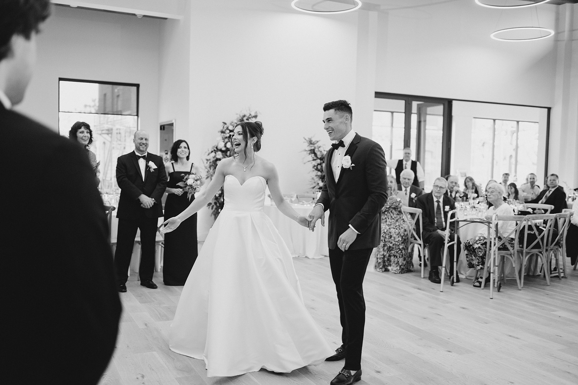 bride and groom walk into wedding reception at Wilbur Mansion