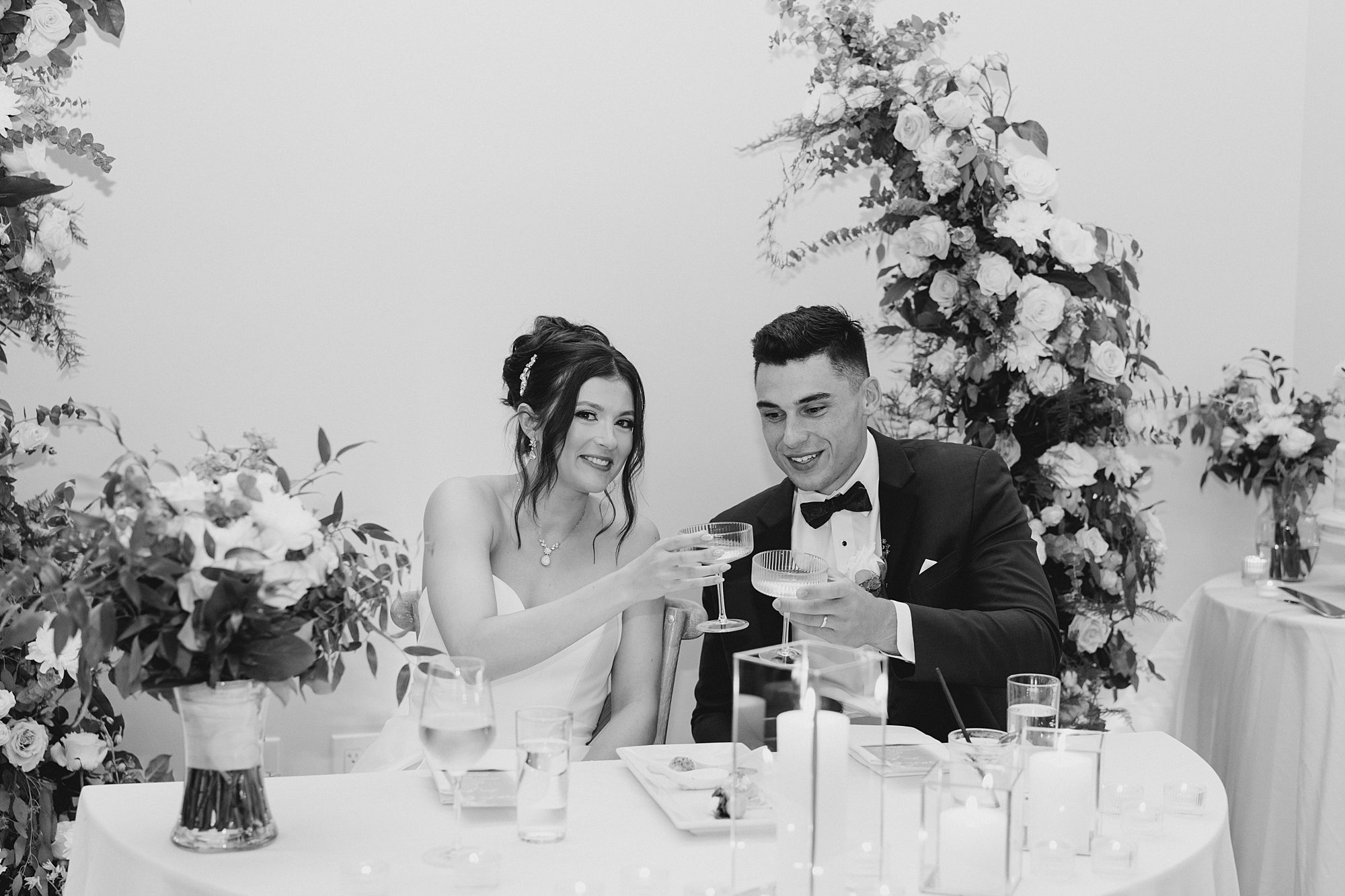 couple cheers during wedding toast