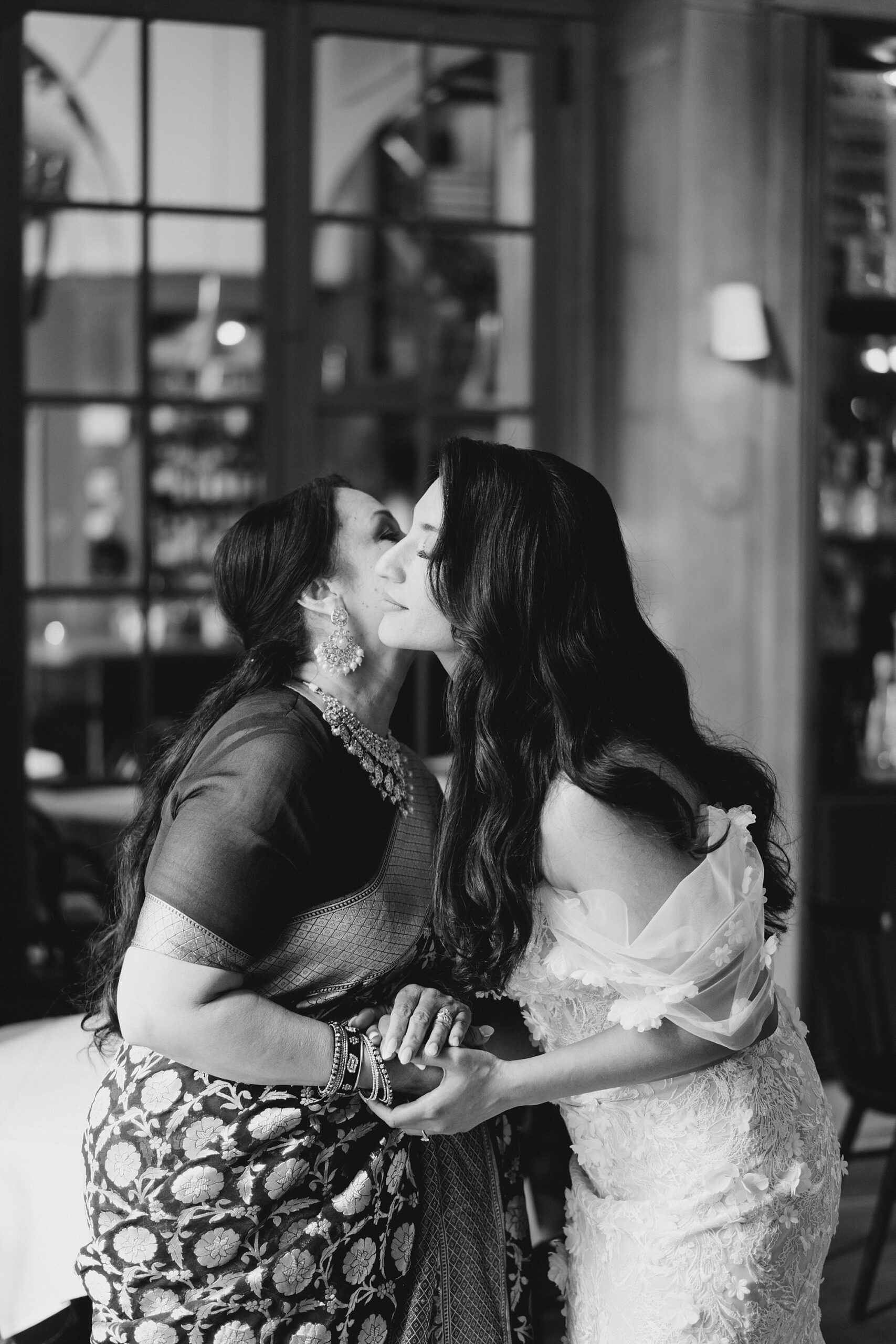 mother of the bride kisses her daughter