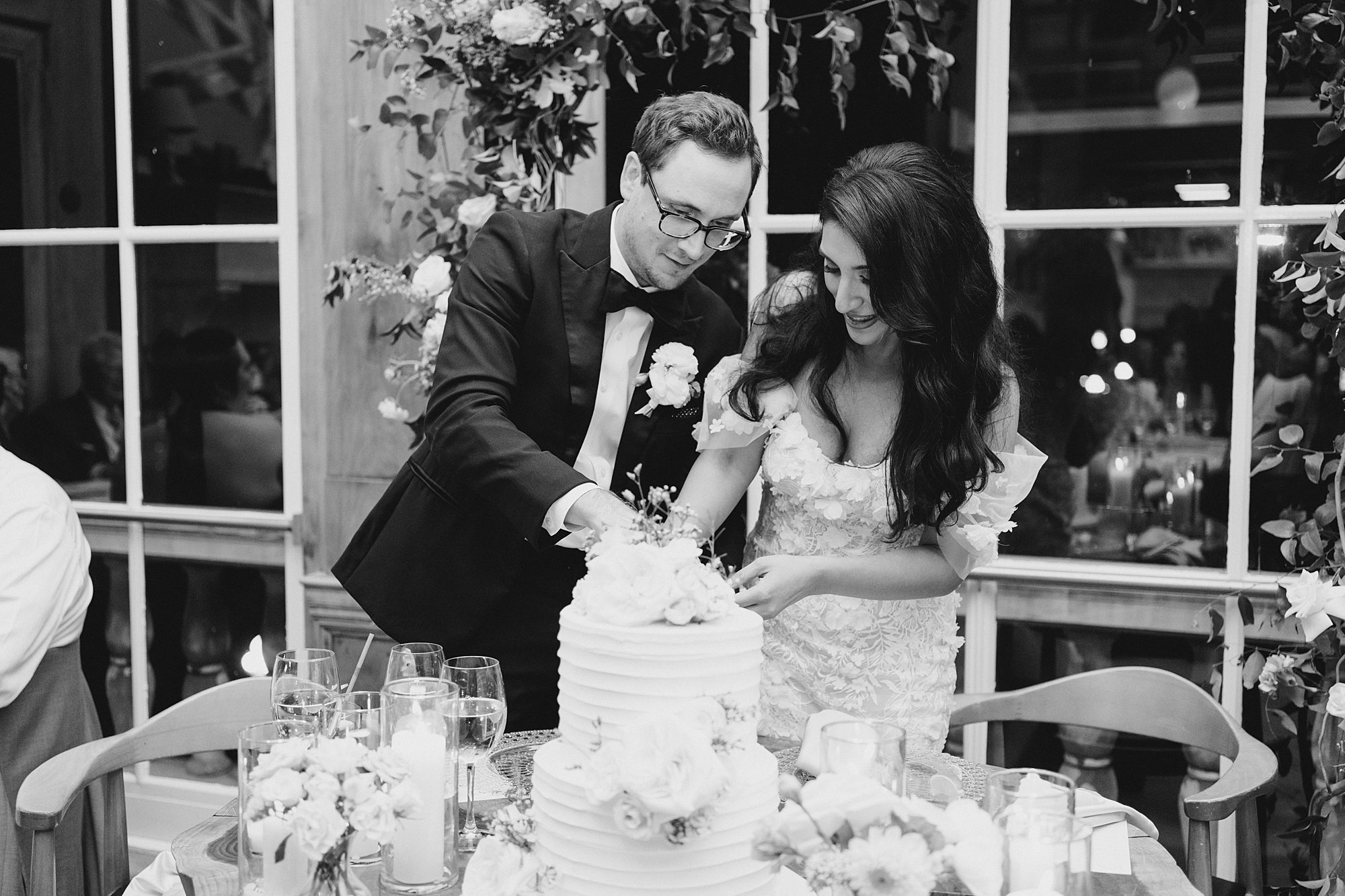 bride and groom cut wedding cake 