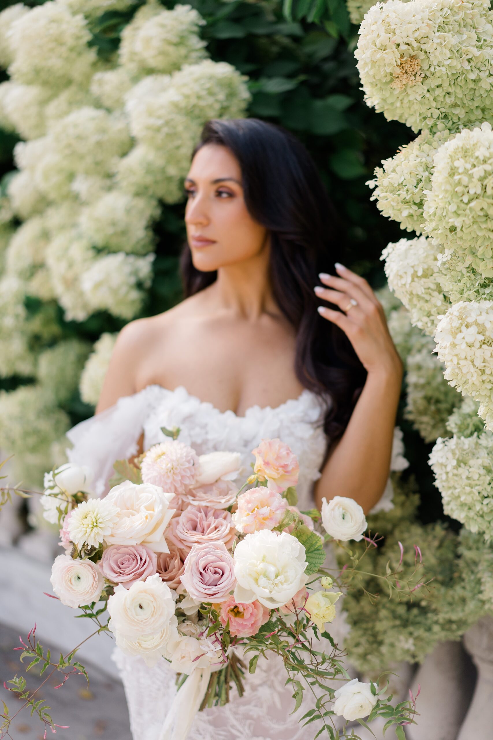 bride holding romantic bouquet of white and pink flowers
