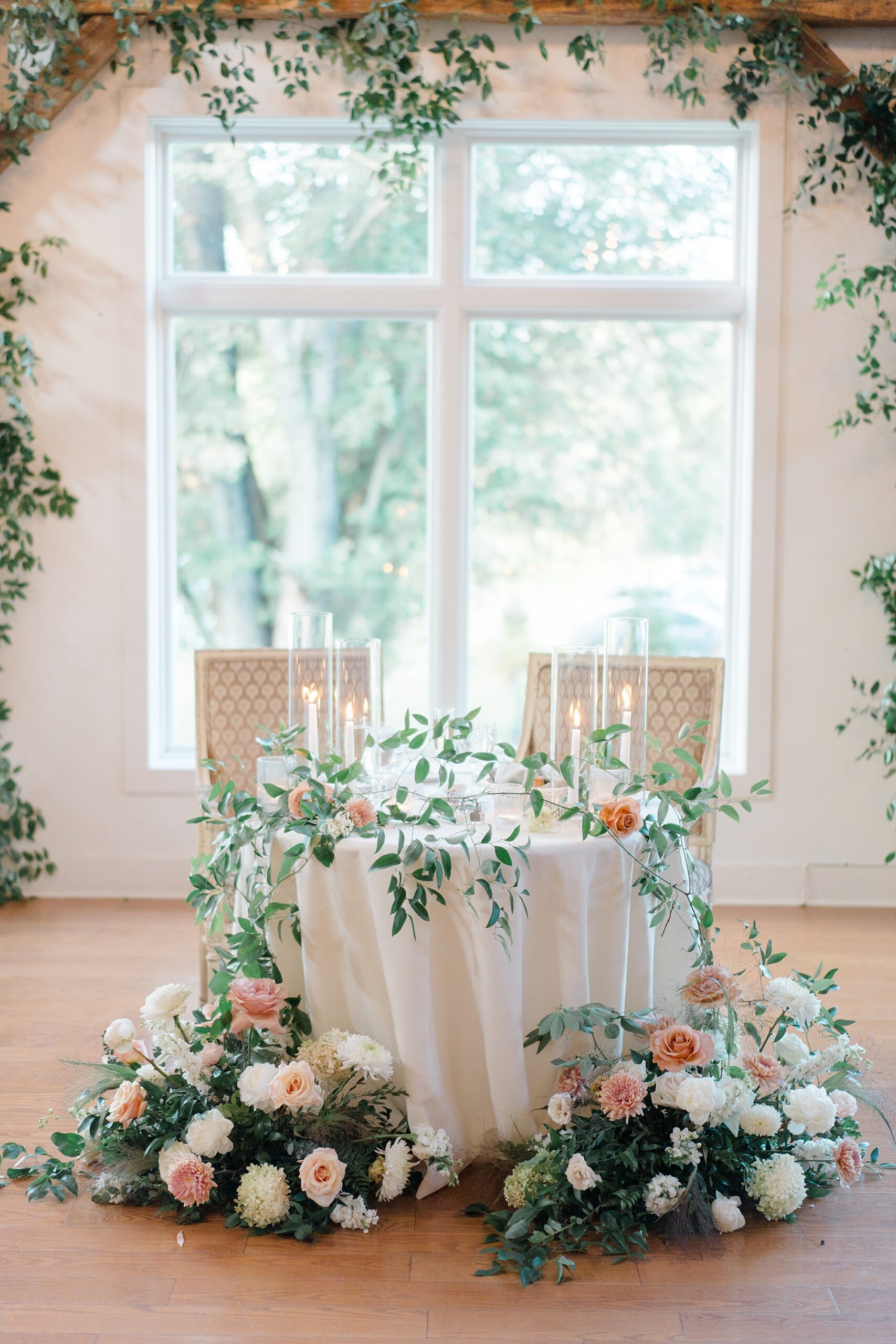 florals surround sweetheart table at reception from Romantic Floral-Centered Wedding at The Inn at Barley Sheaf Farm