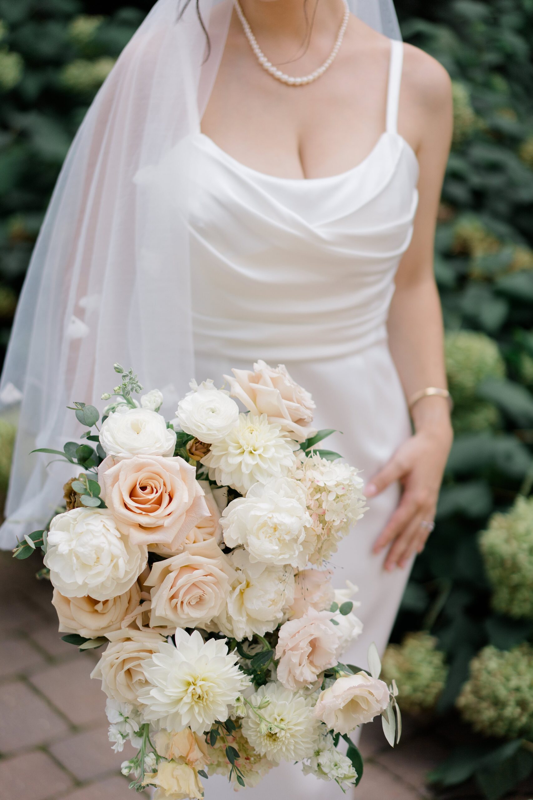 elegant bridal portraits and bridal bouquet of pale orange and white flowers