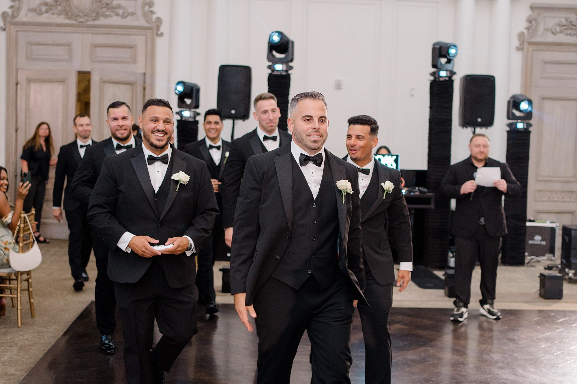 groomsmen enter wedding reception 