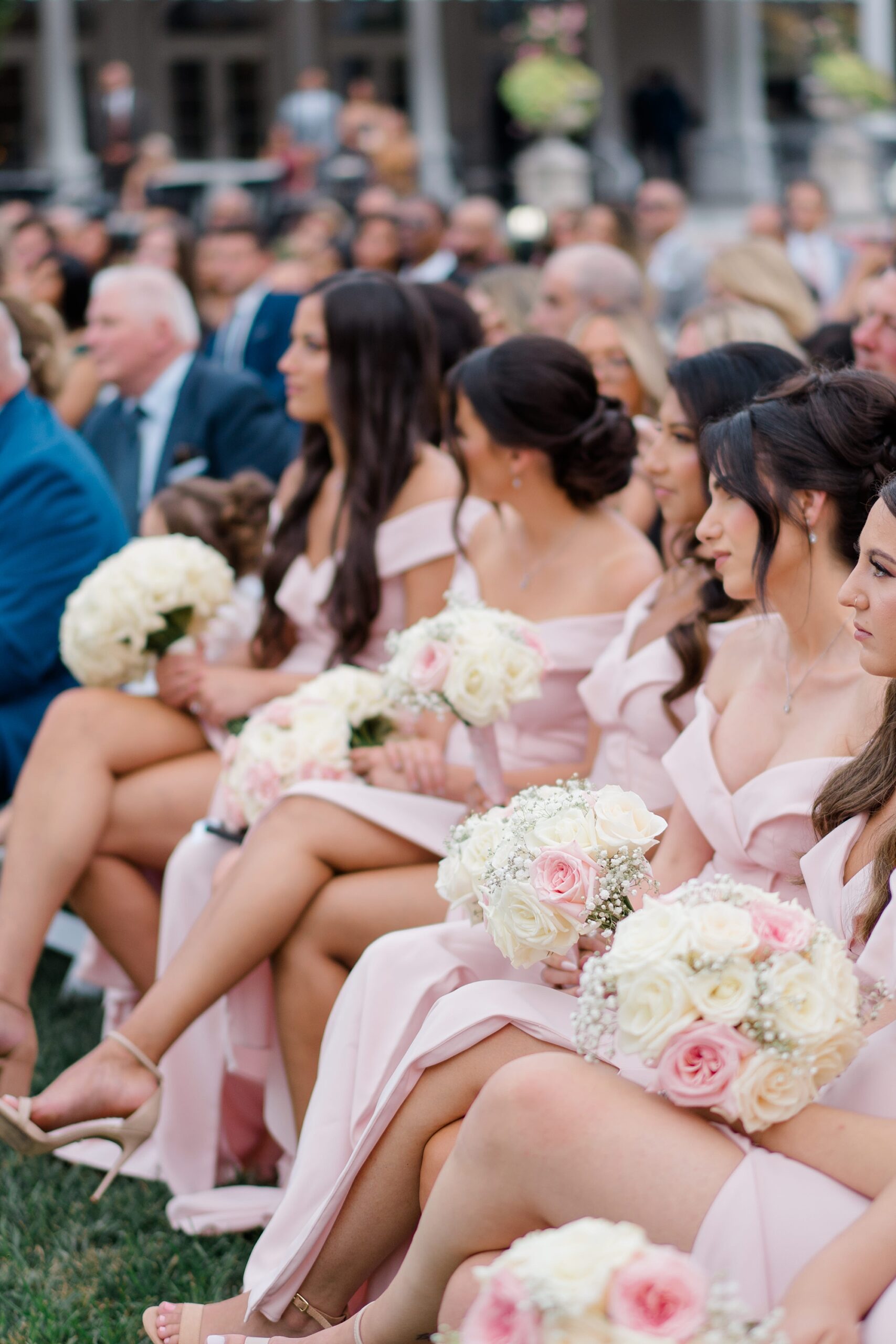 bridesmaids sit during wedding ceremony