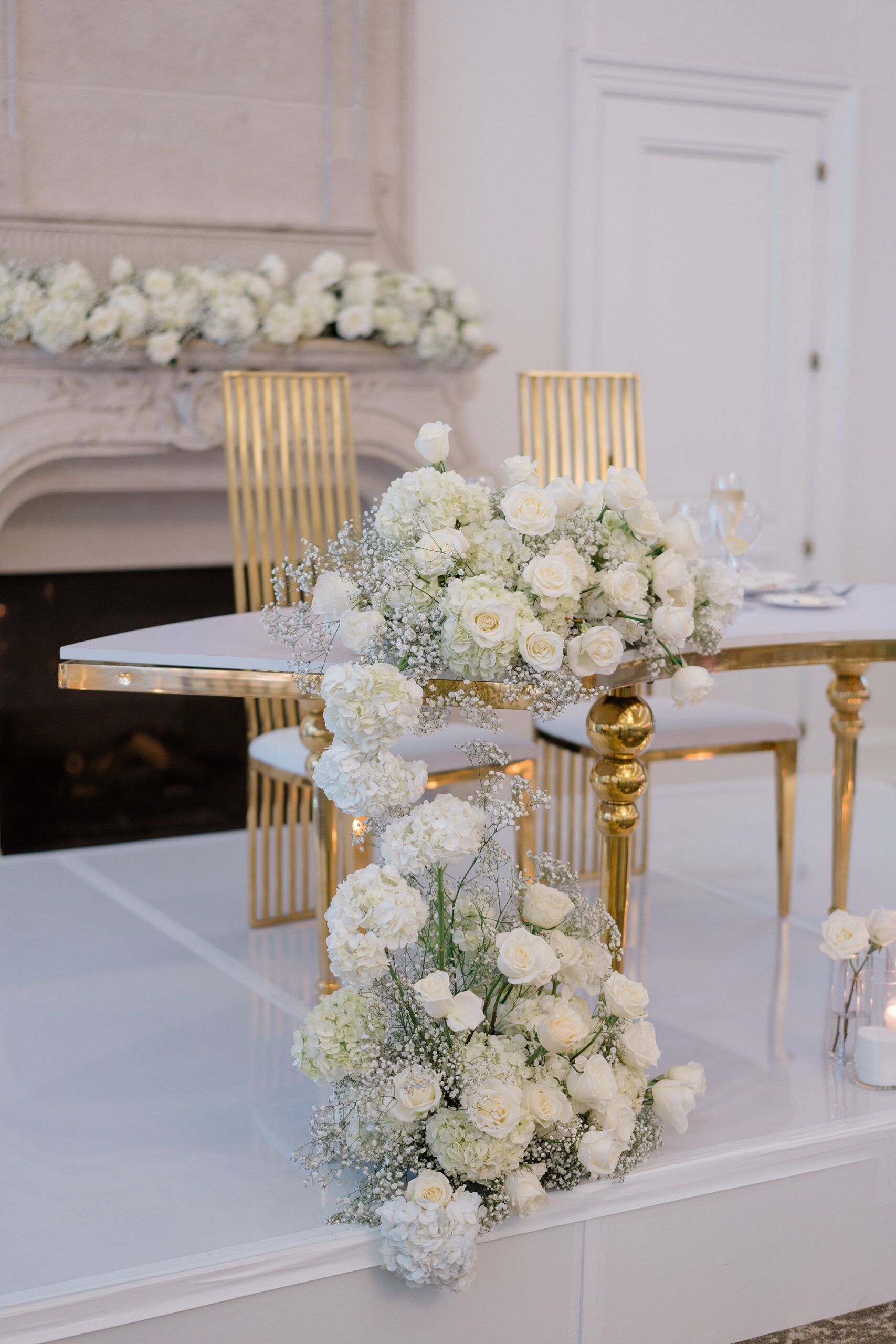 white roses and babys breath decorate Romantic Park Chateau Wedding reception 