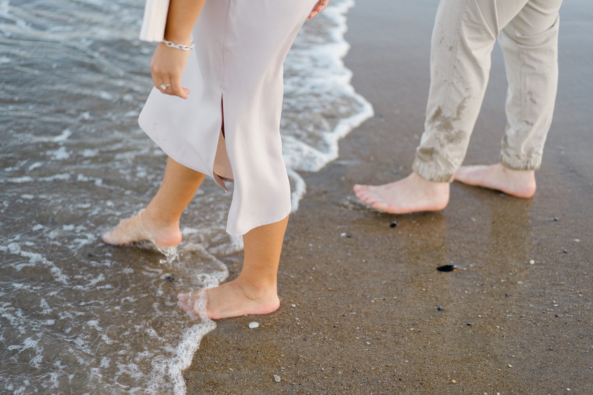 couple walk in the water during Dreamy Beach Engagement  