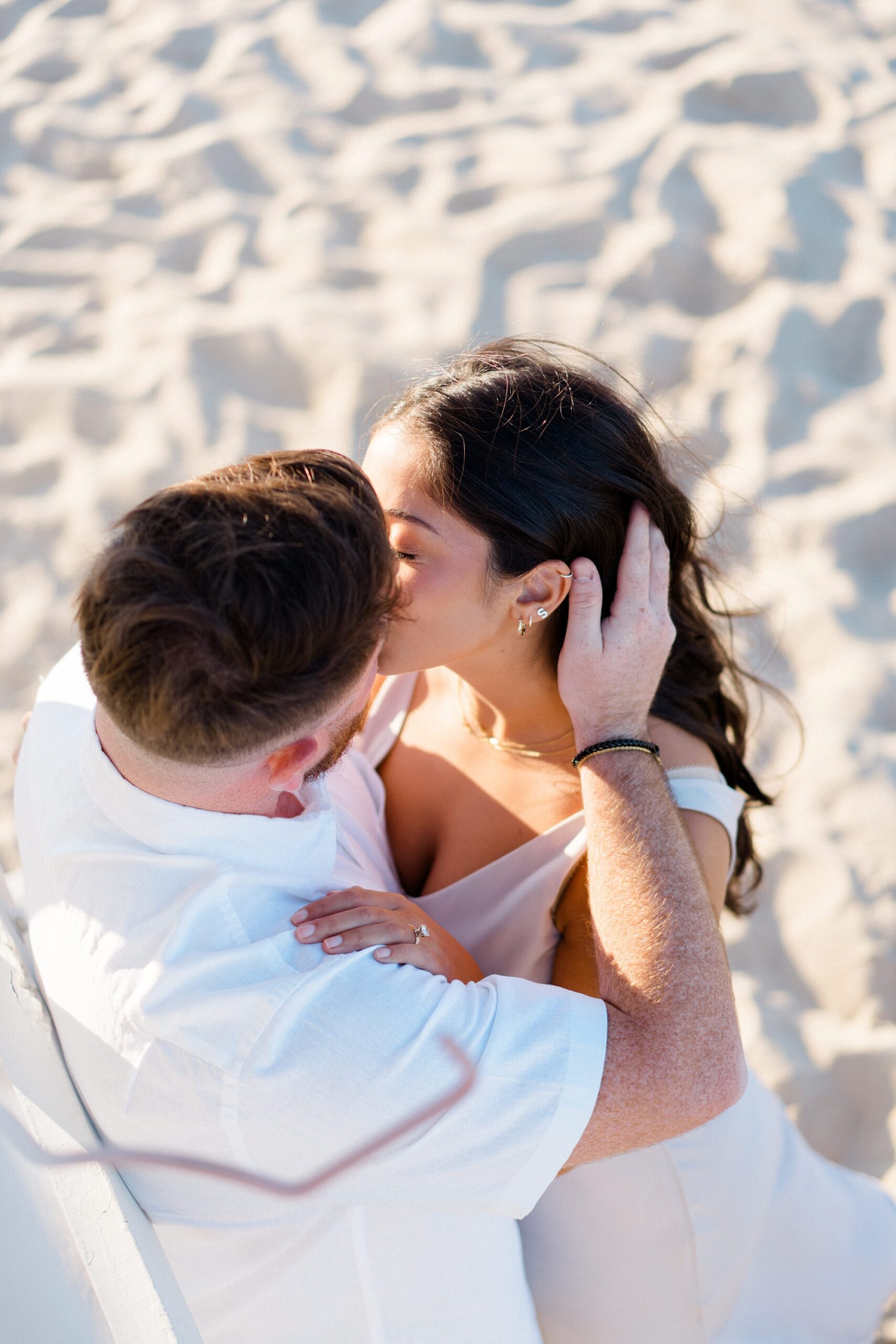 couple kiss during Dreamy Beach Engagement  