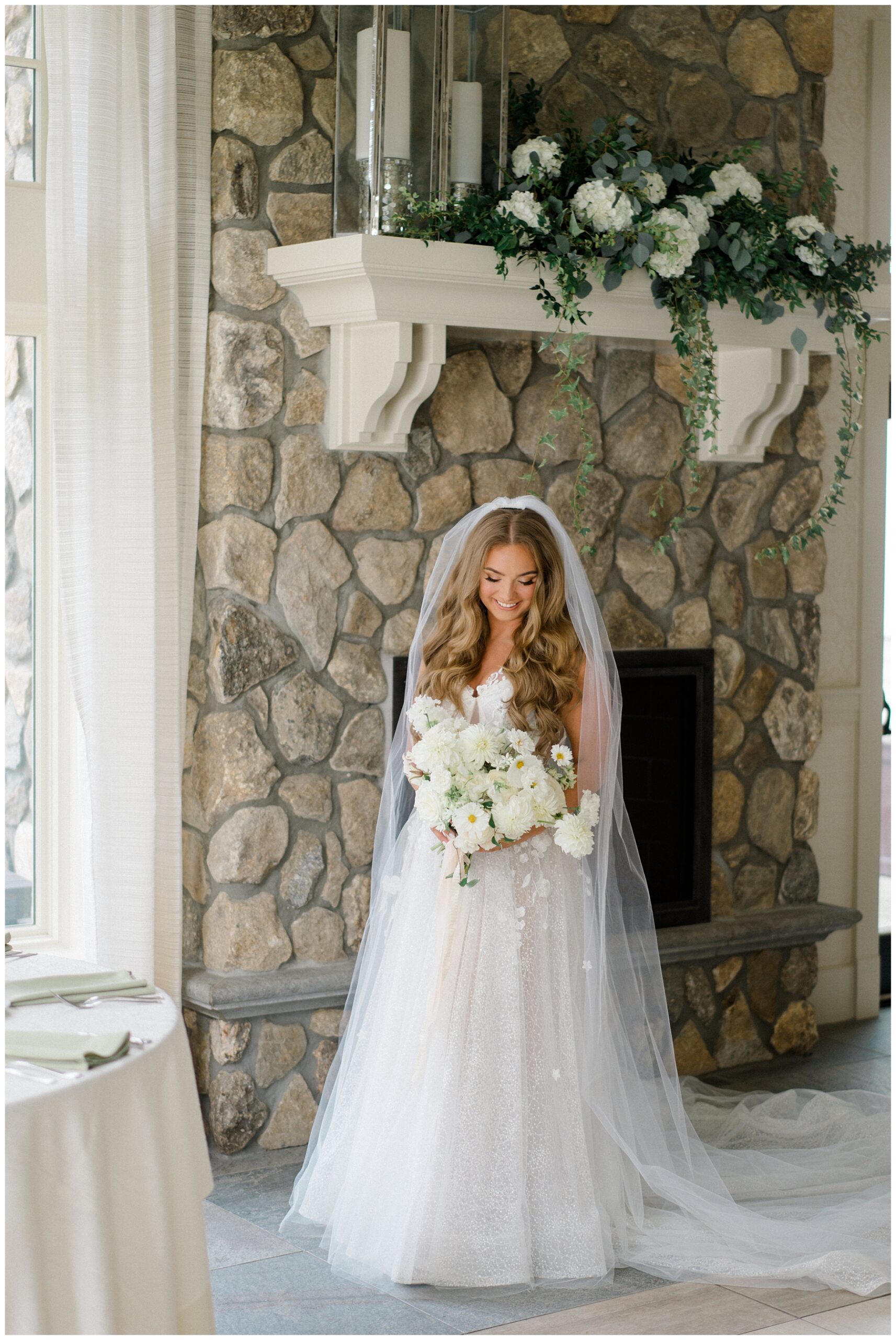 bride in wedding dress holding white flower bouquet 