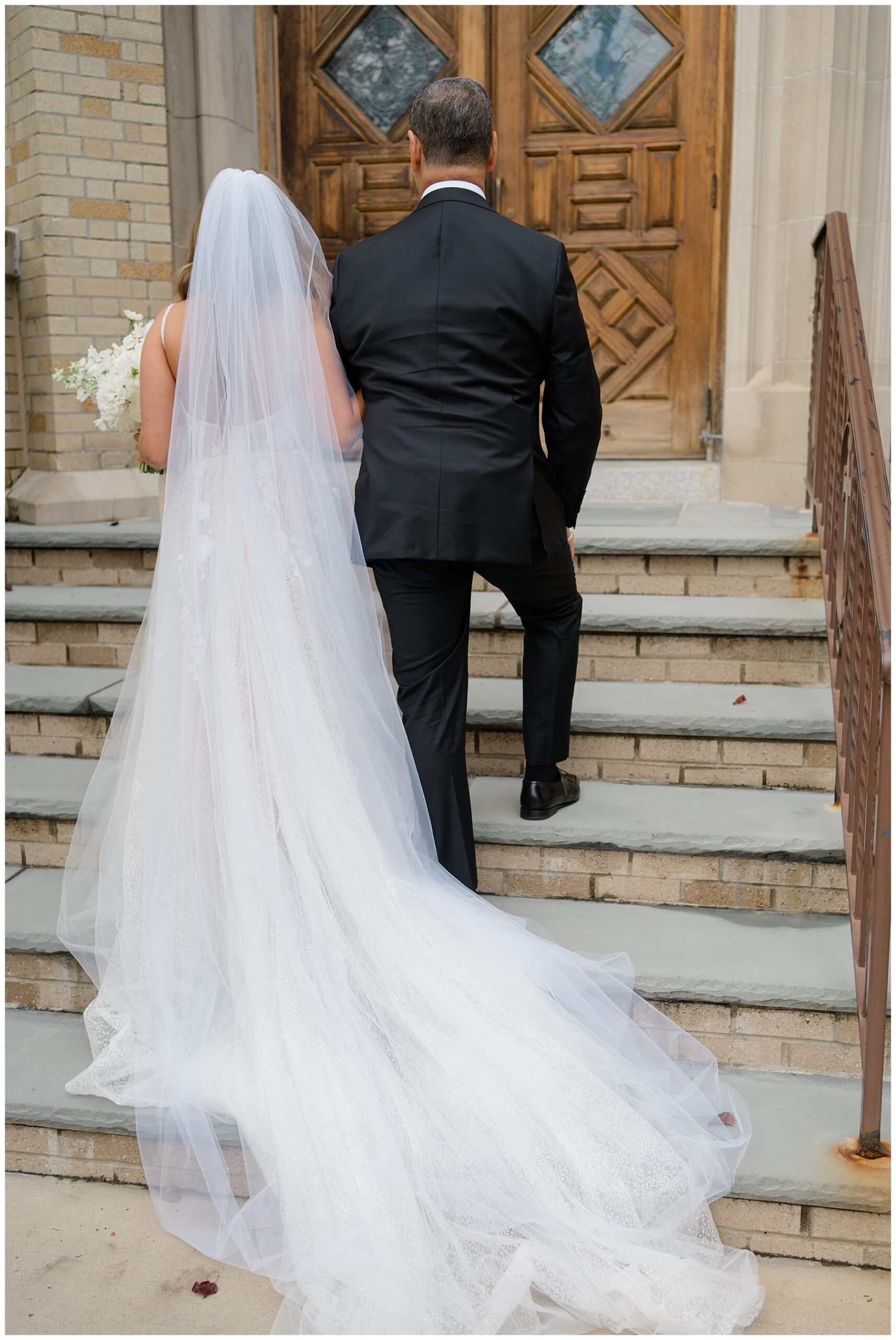 bride and father walking into church