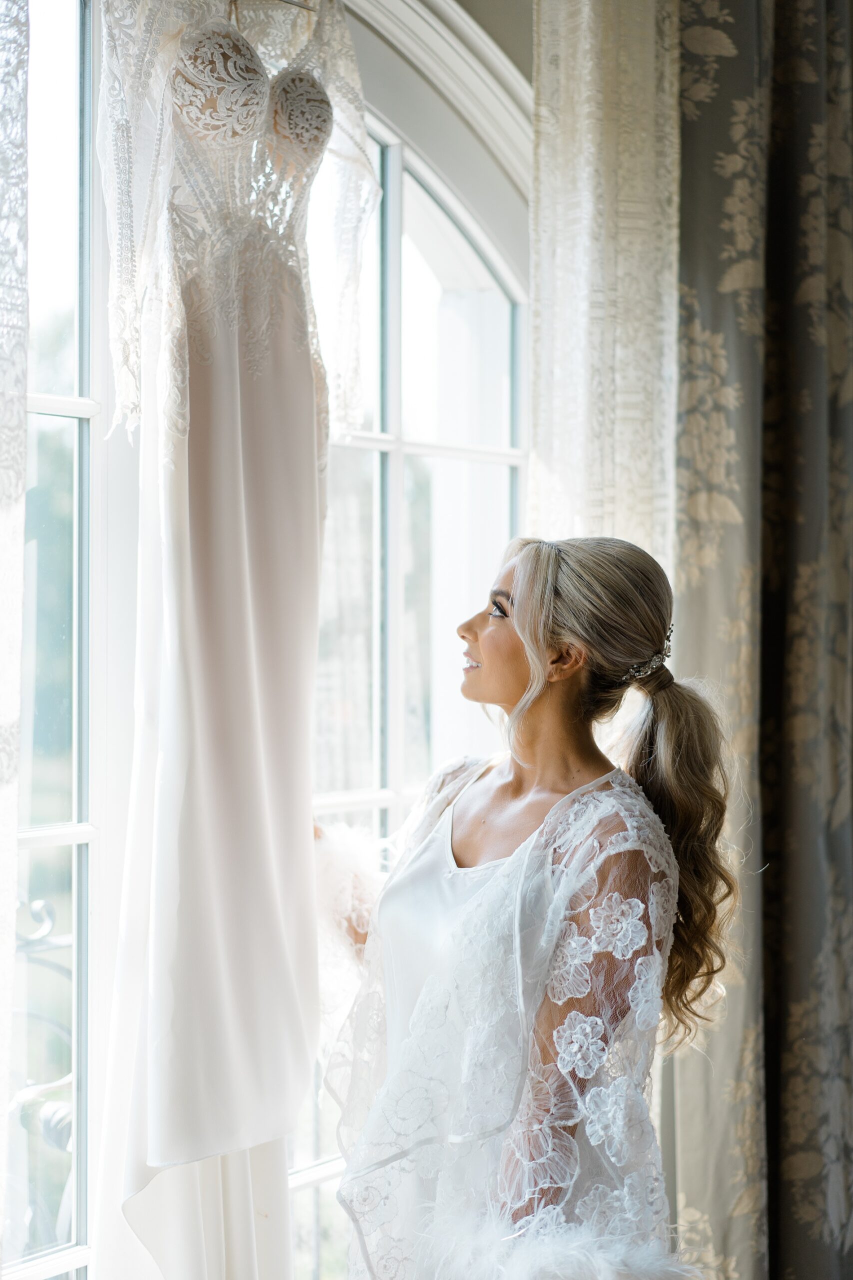 bride admires wedding gown