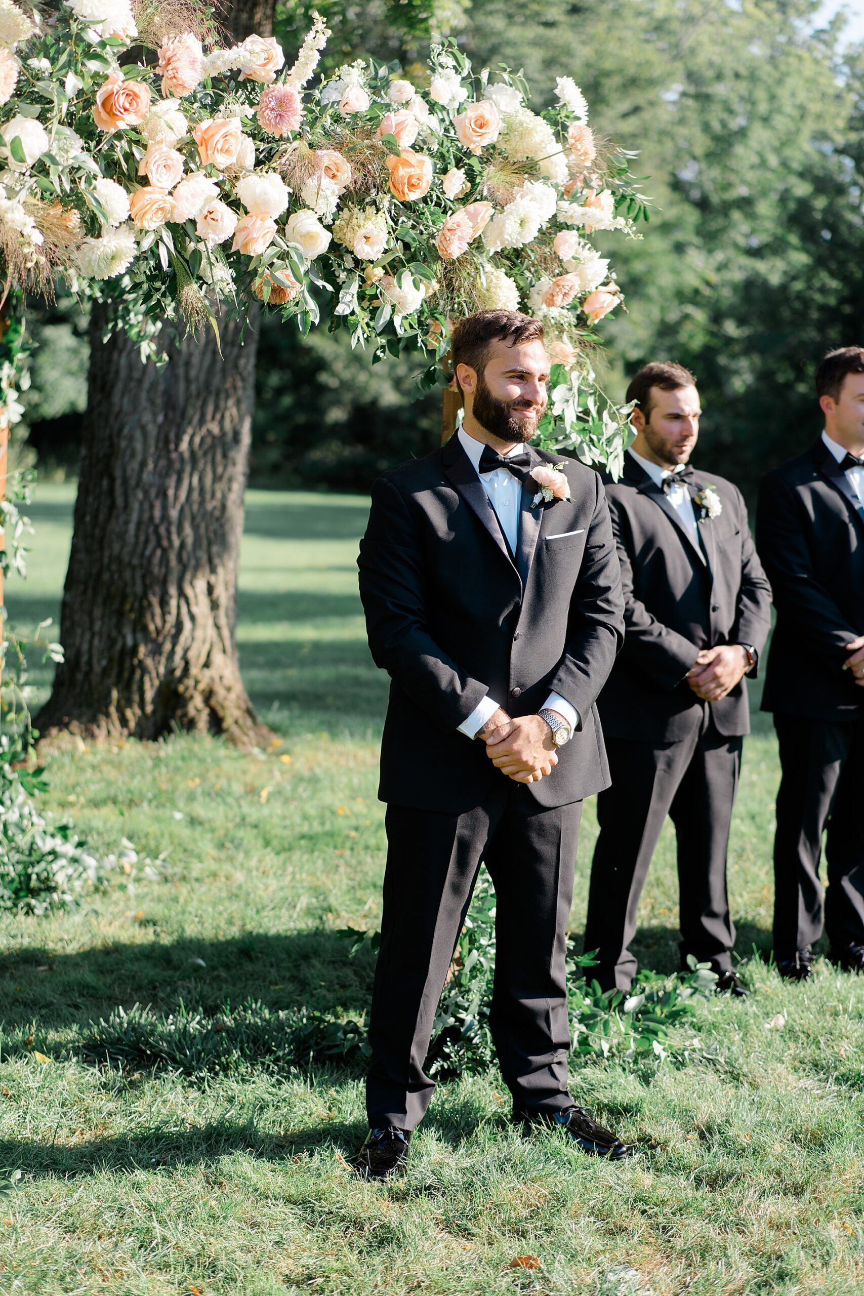 groom waits for his bride during outdoor ceremony from Romantic Floral-Centered Wedding at The Inn at Barley Sheaf Farm