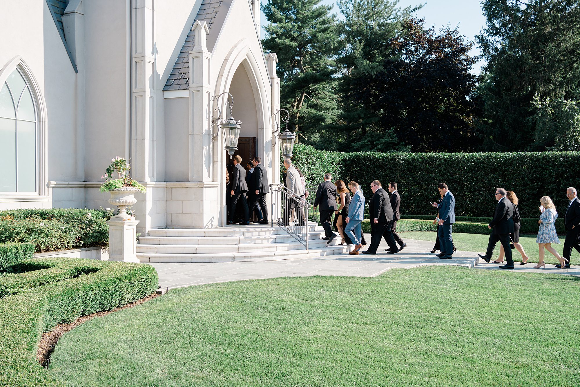 guests enter chapel for Timeless Park Chateau Wedding