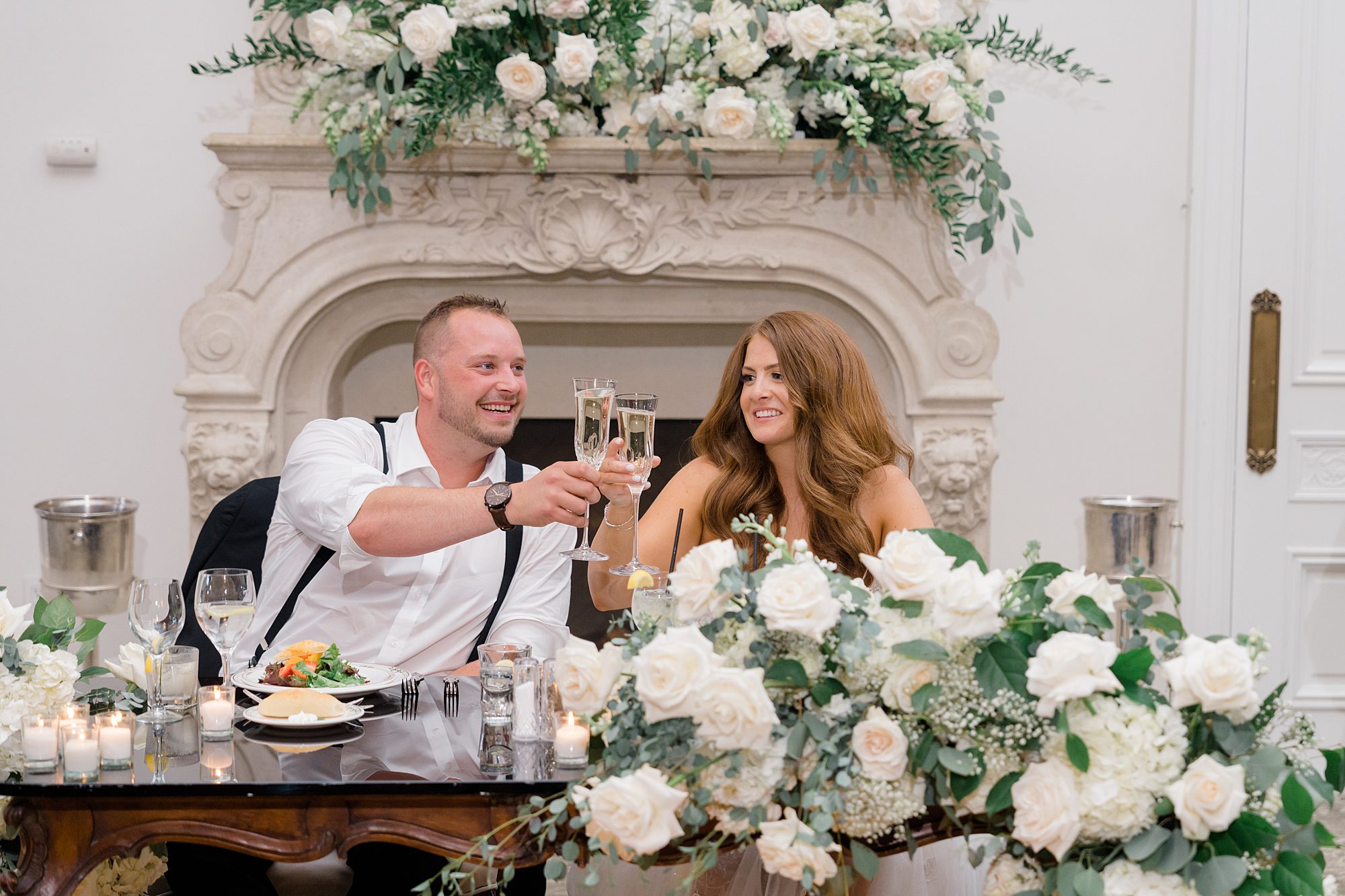 newlyweds cheers during wedding toasts 
