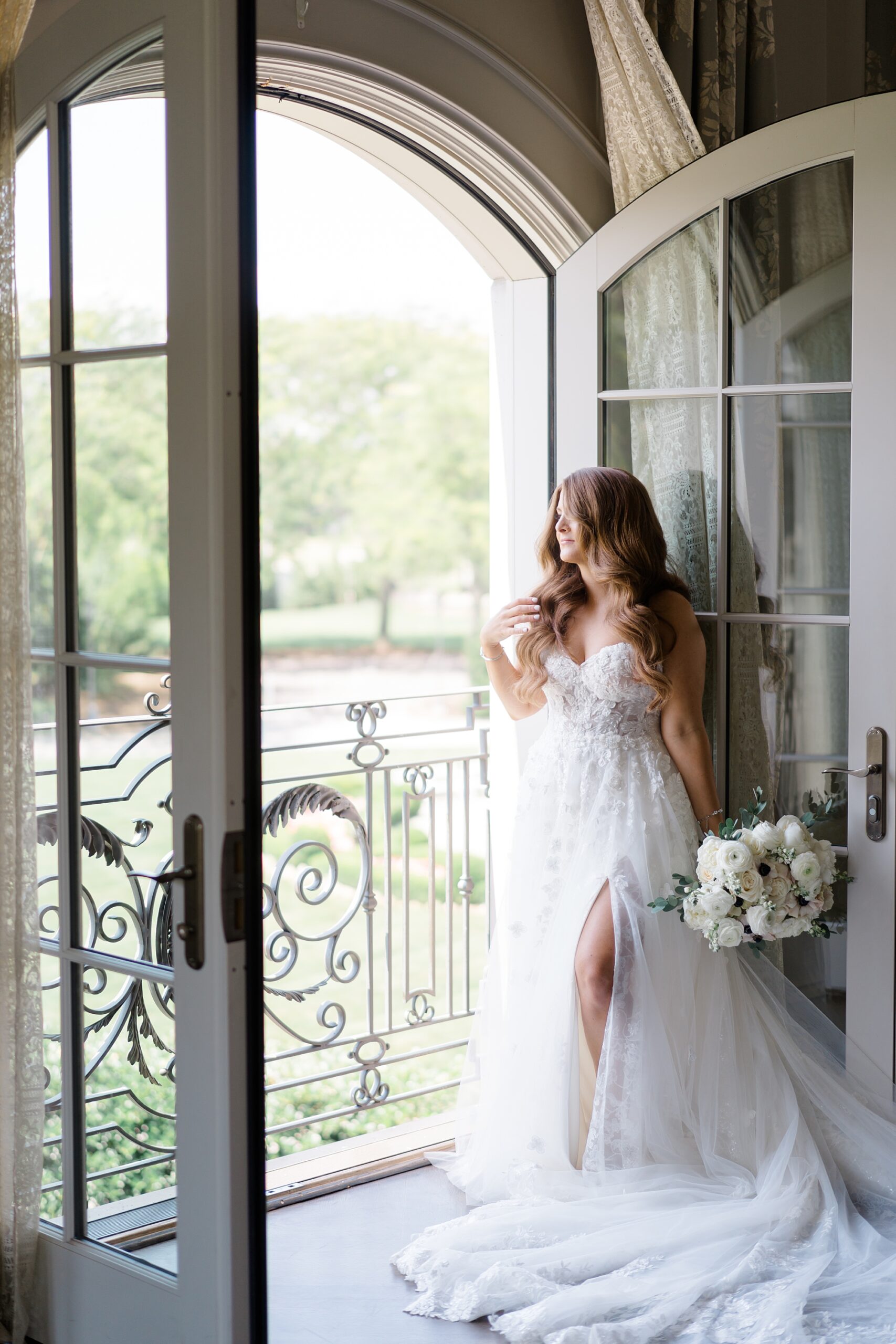 bride looking out of balcony from Timeless Park Chateau Wedding