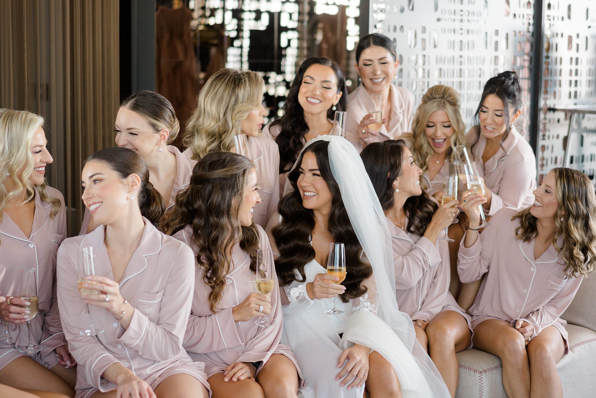 bride and bridesmaids toasting with champagne 