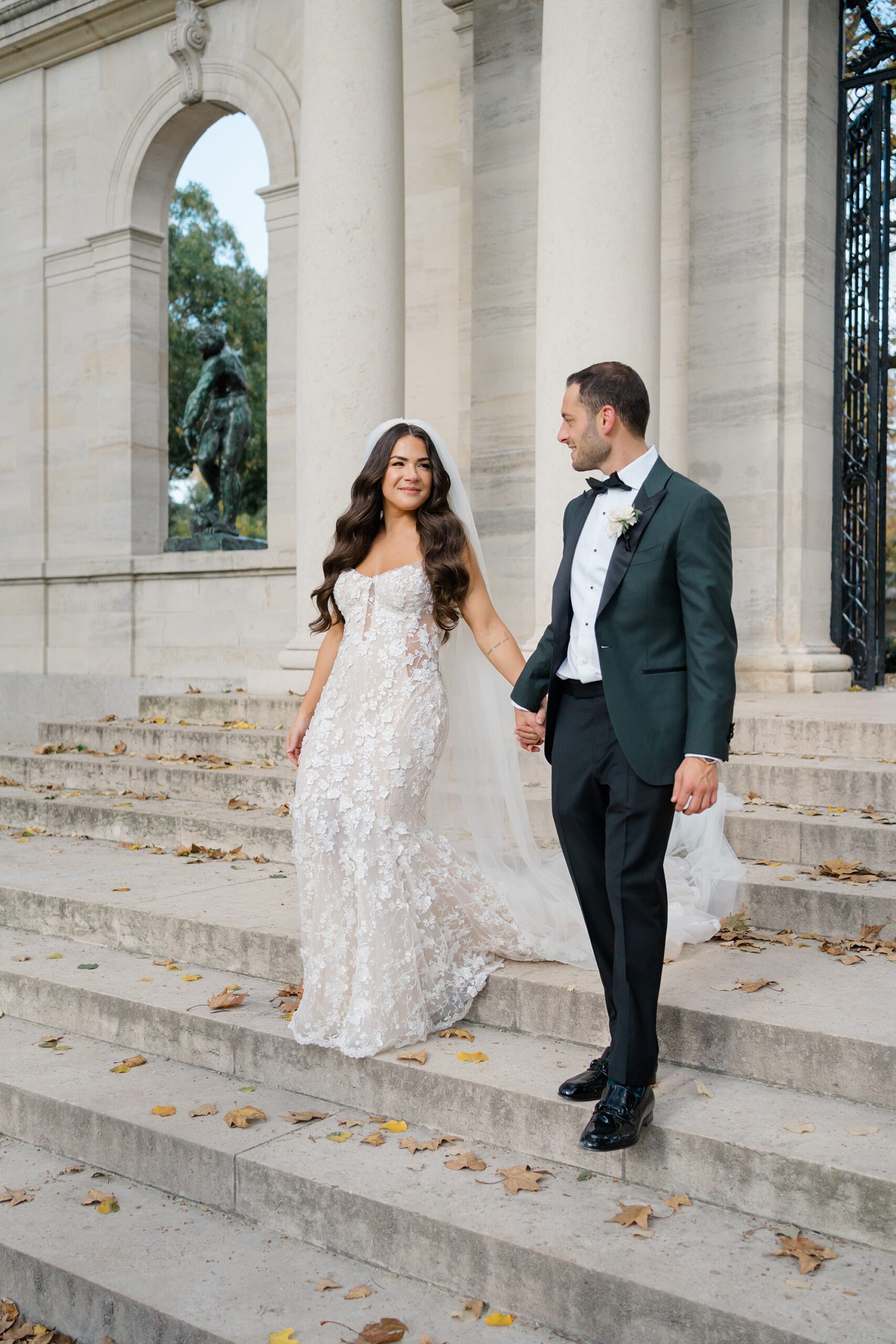 bride and groom walk down steps at Rodin Museum 