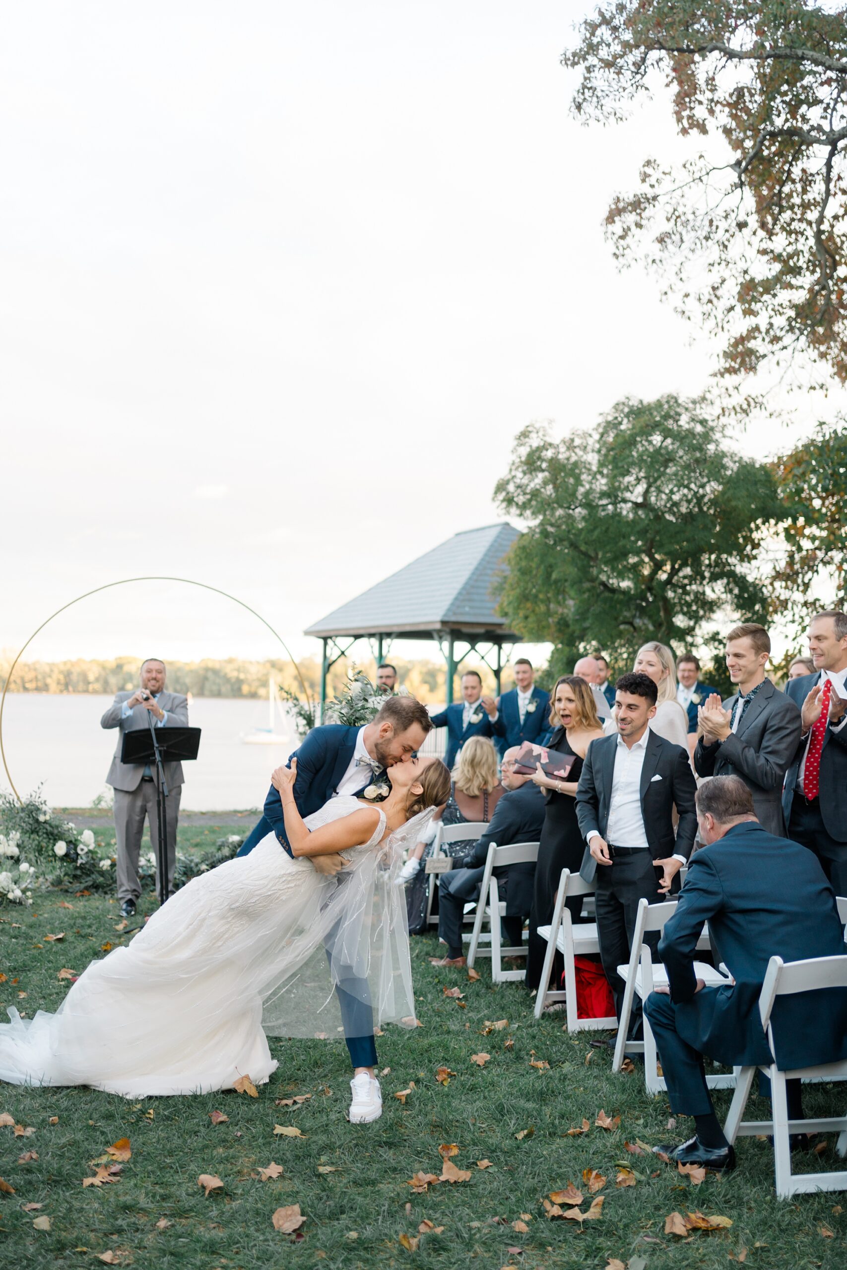 groom dips and kisses his bride as they exit wedding ceremony