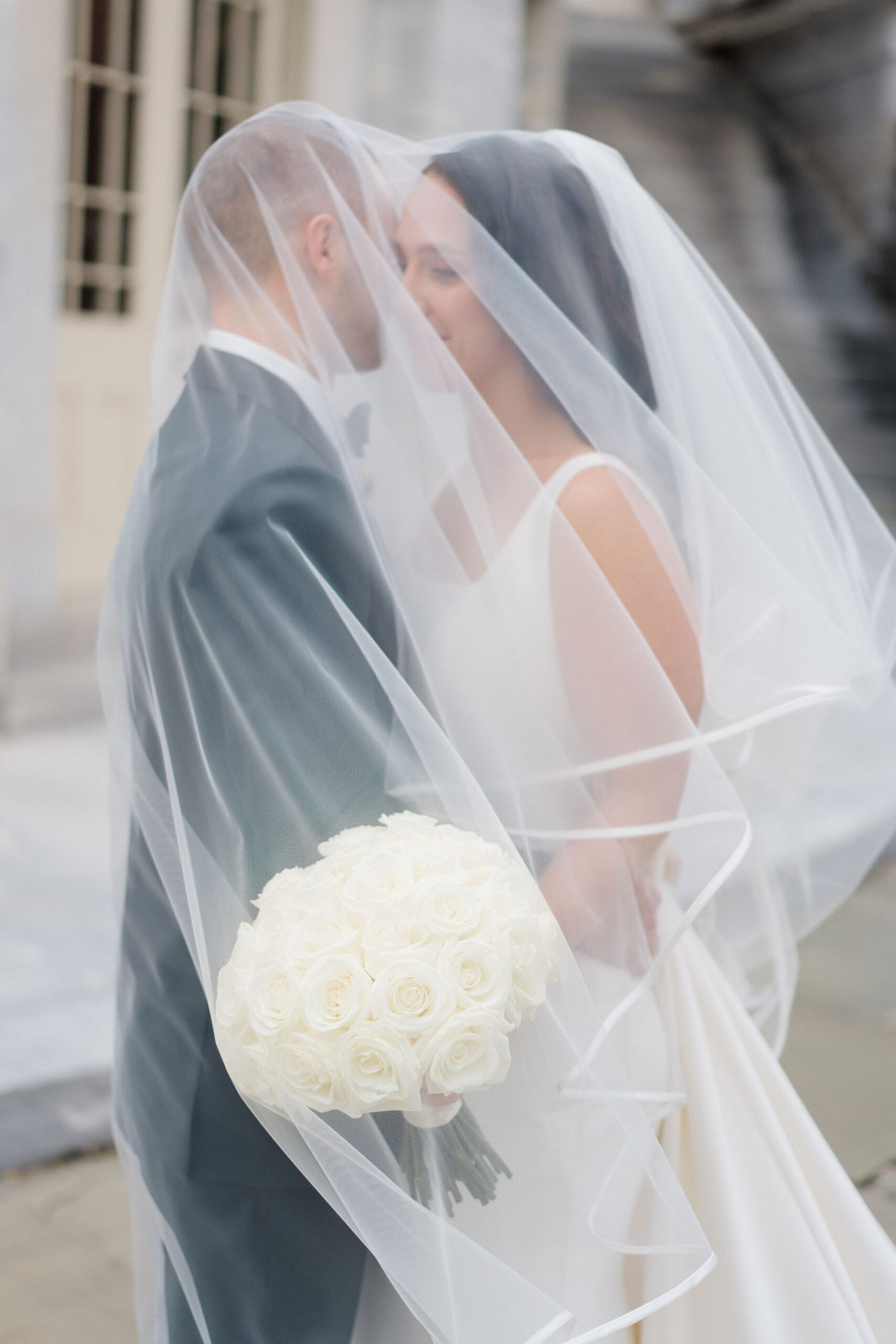 Romantic wedding portraits under bride's veil