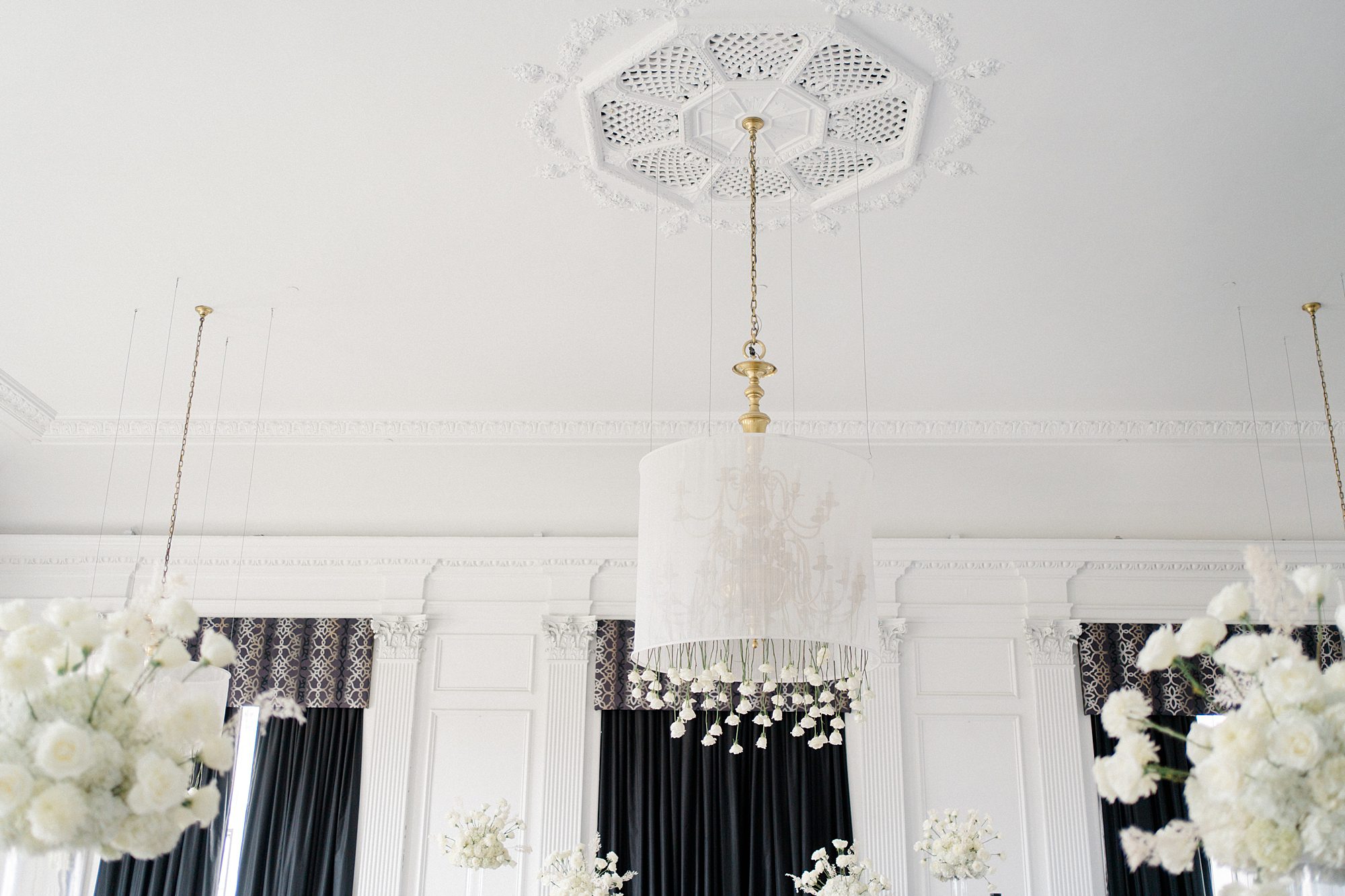 flowers hanging from chandelier and ceiling