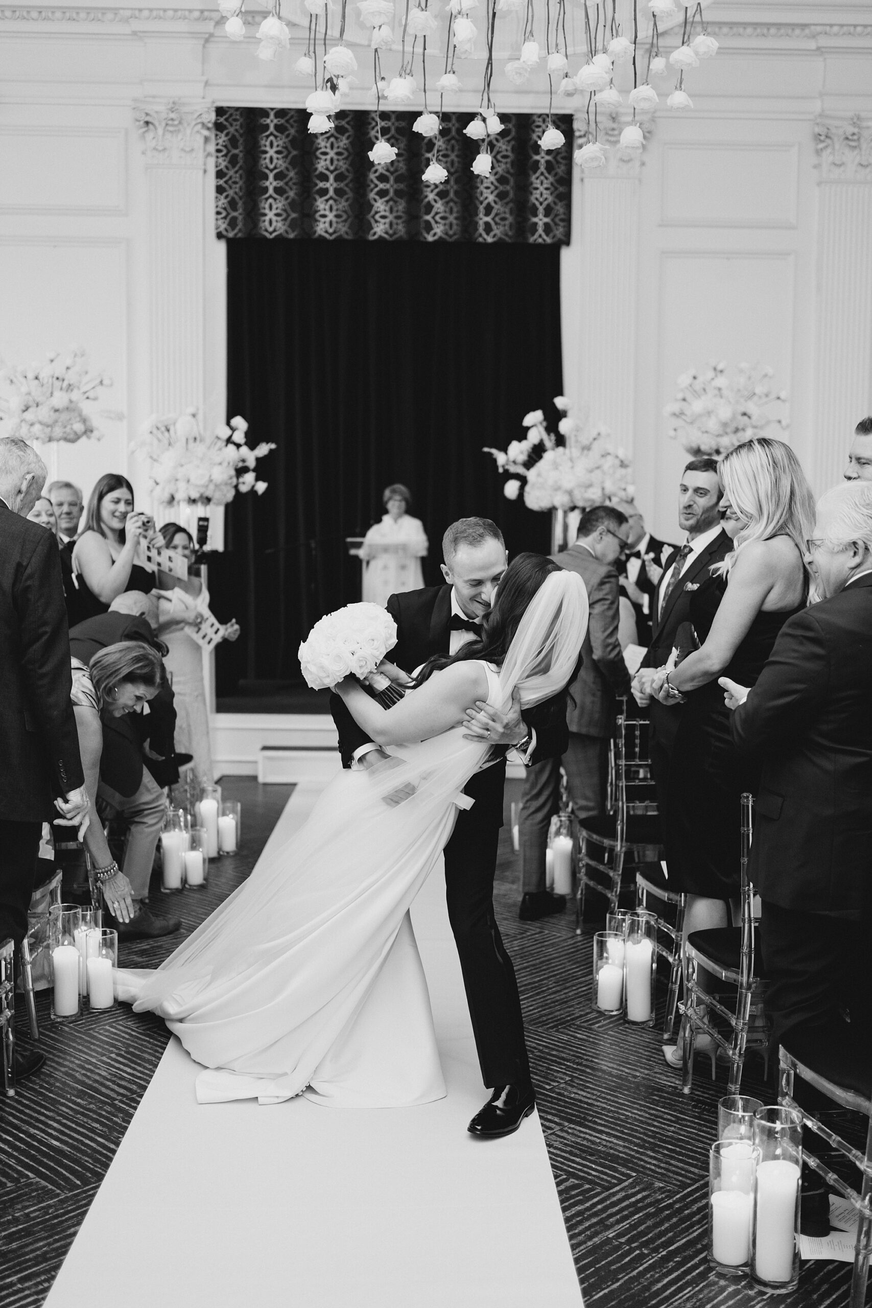 groom dips his bride as they exit