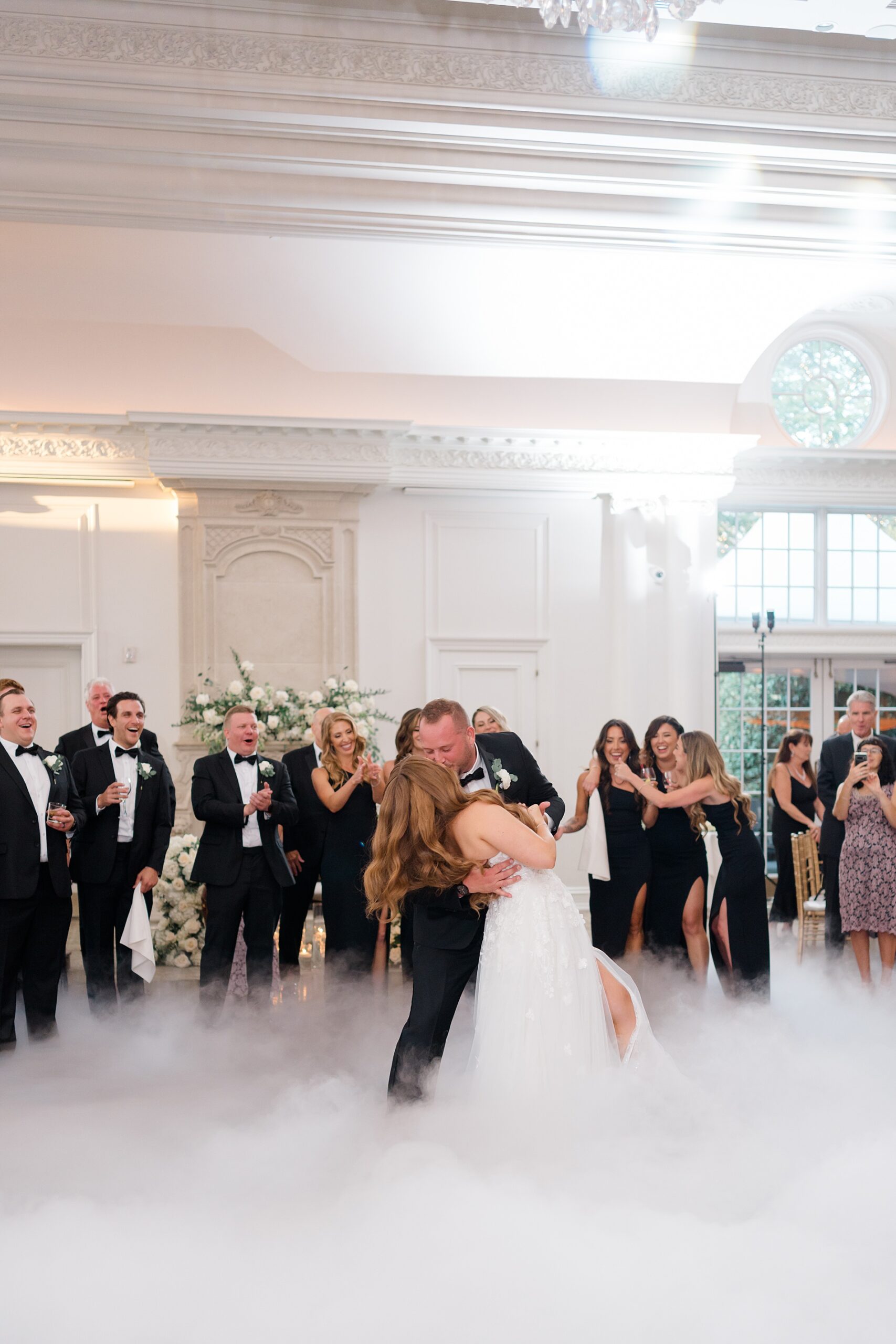 groom kisses bride on dance floor