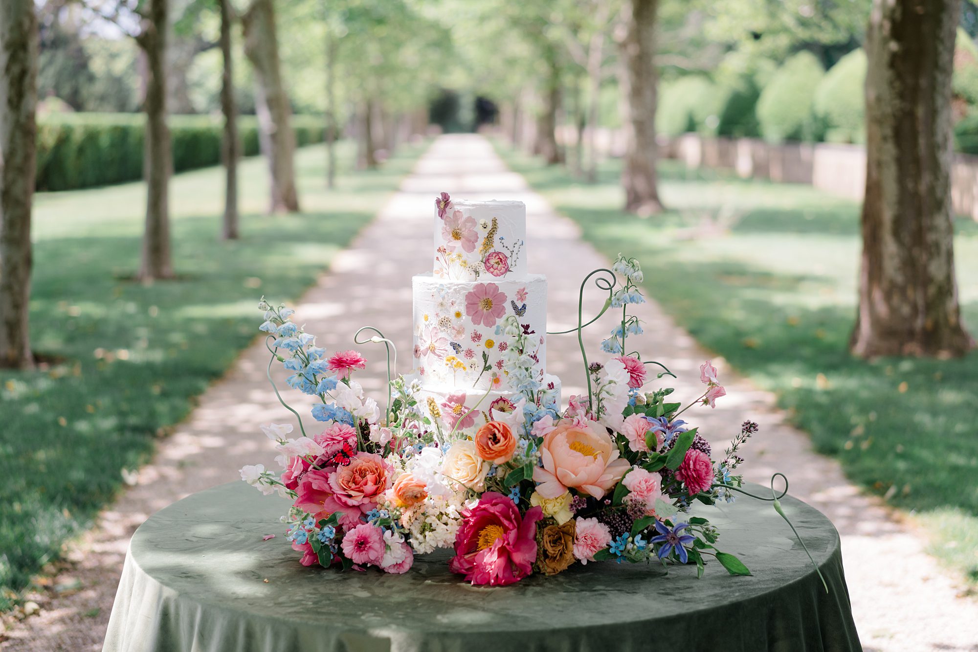 vibrant wedding florals around wedding cake