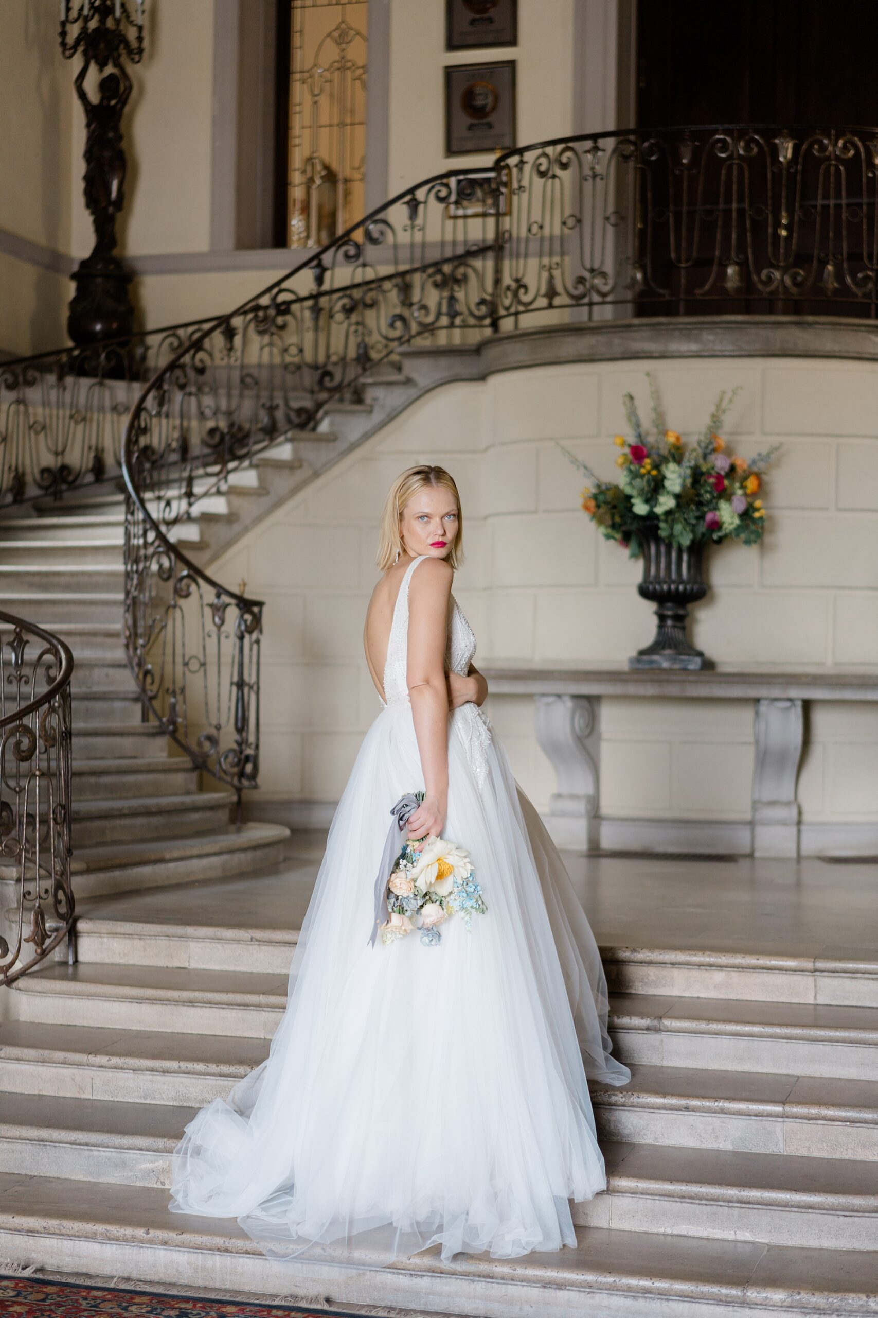 bride on grand staircase of Oheka Castle