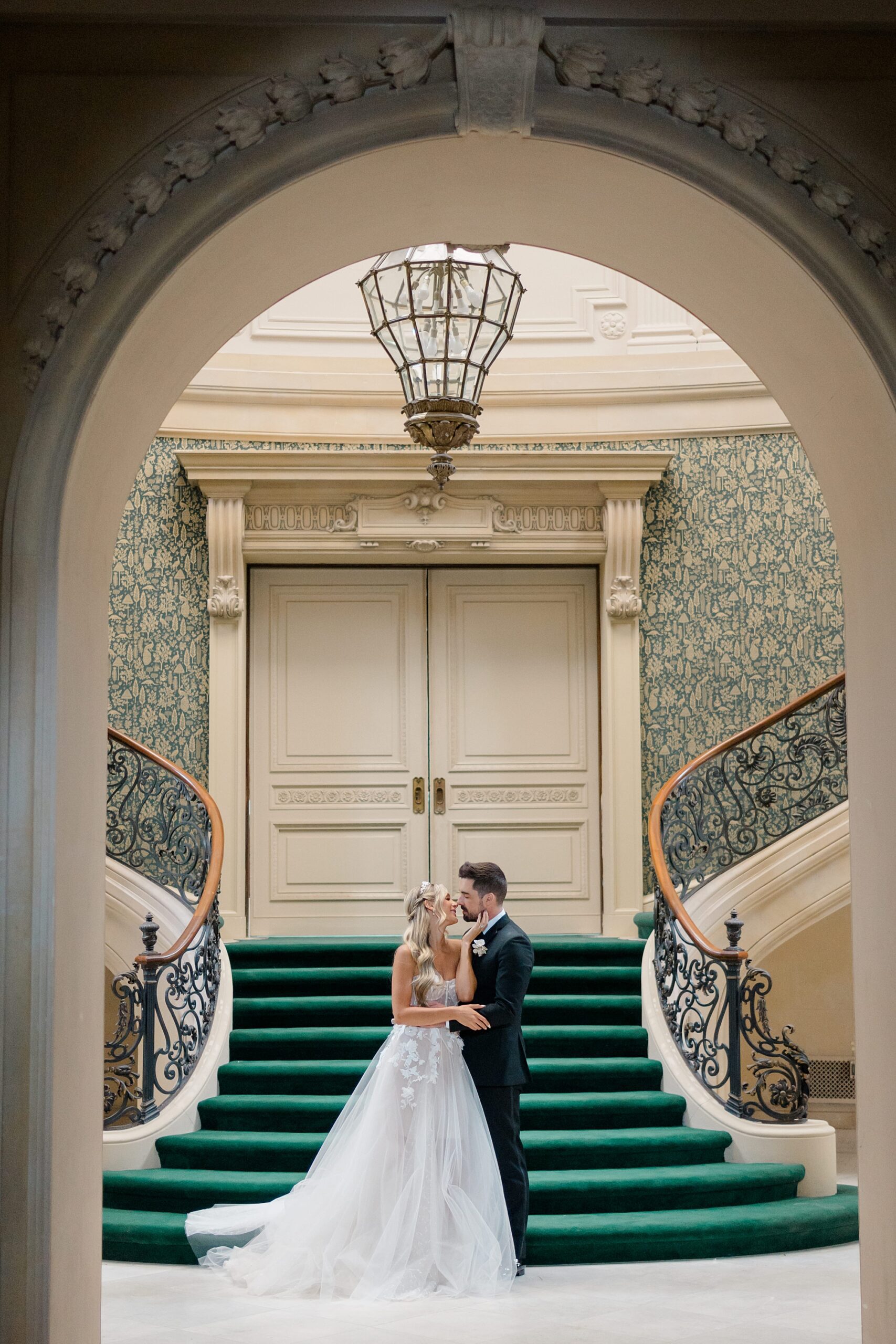 wedding portraits in front of staircase at Elstowe Manor 
