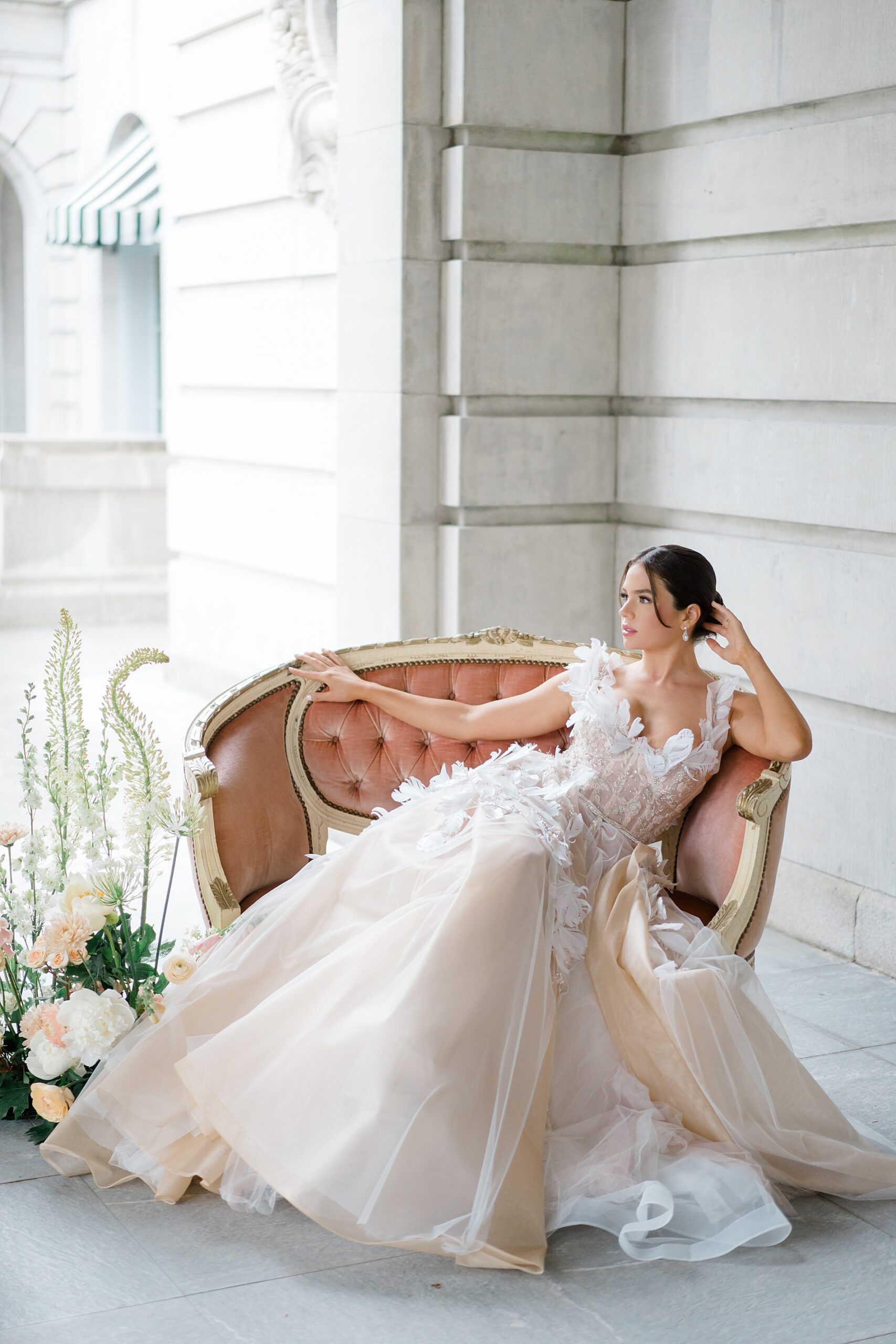 bride sits on elegant couch 