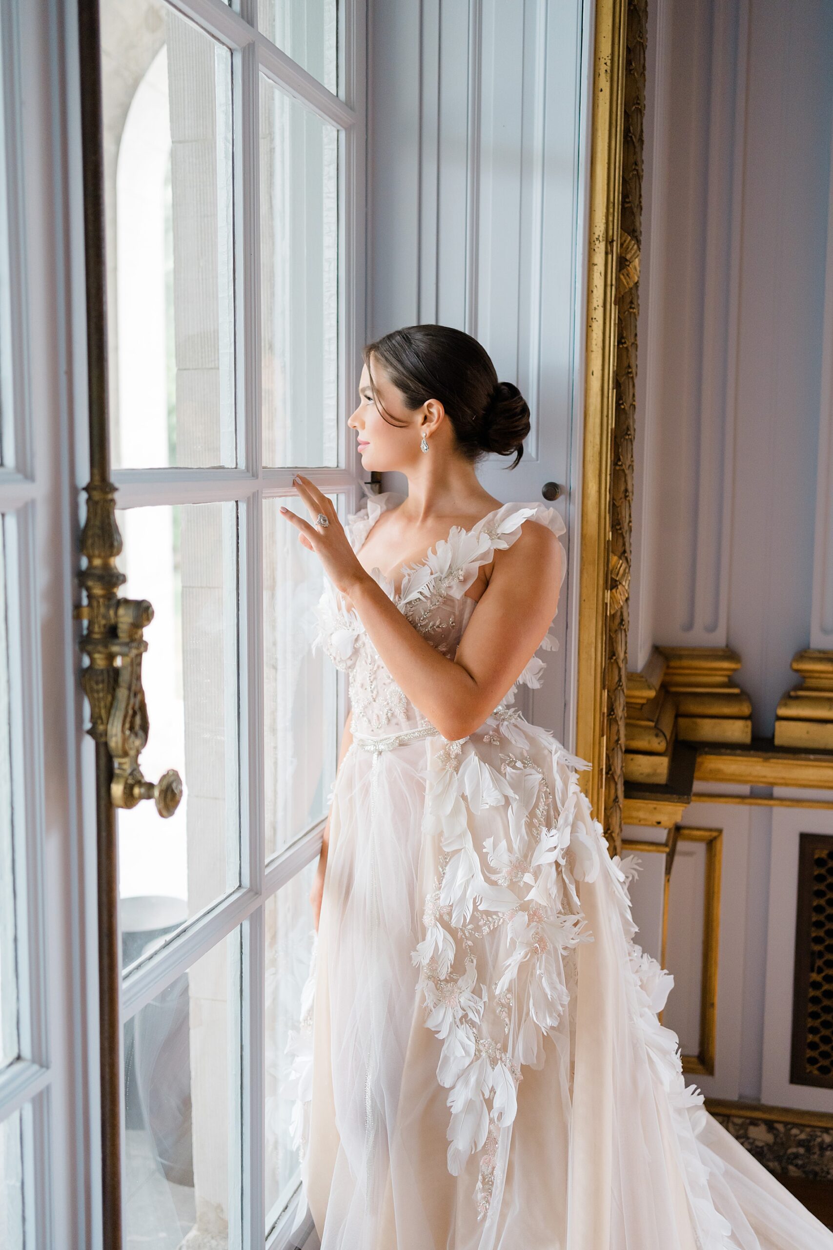 elegant bride looking out window