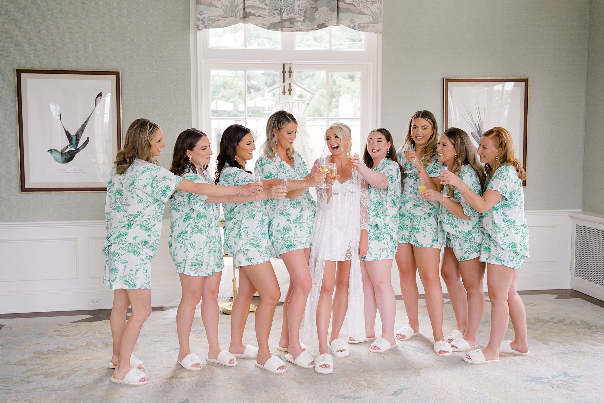 bride and bridesmaids toasting with champagne