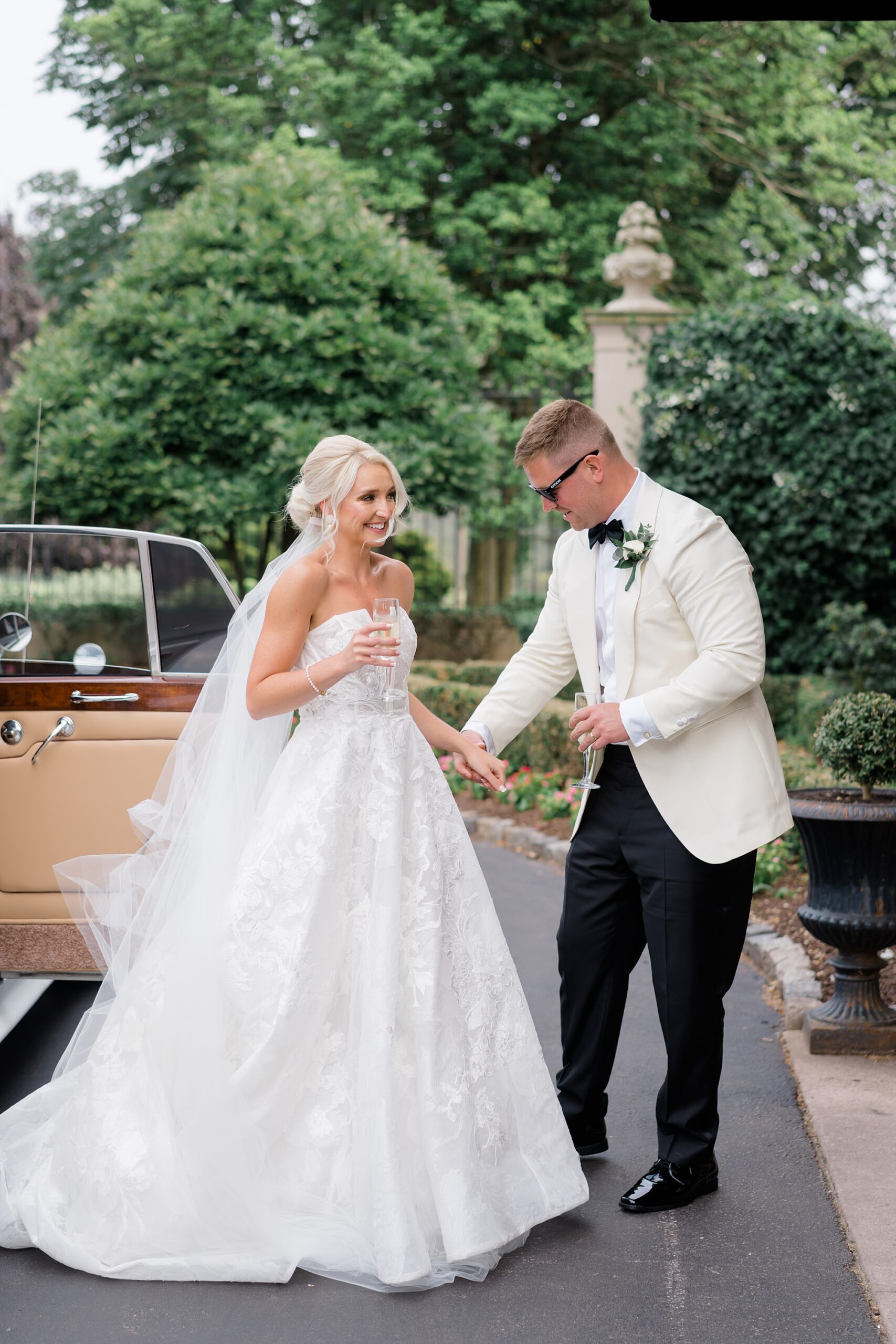 bride and groom exit Rolls Royce 