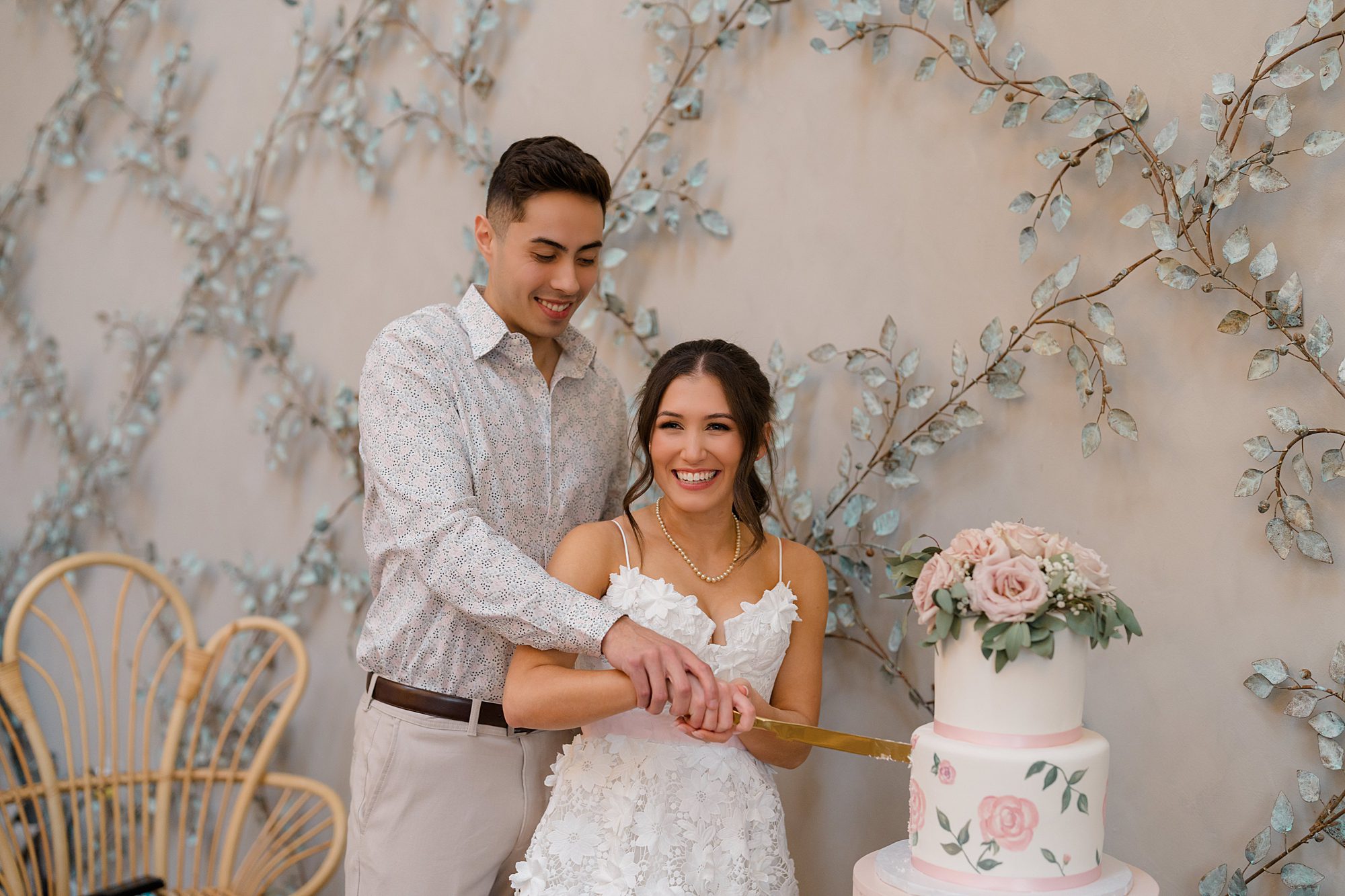 soon-to-be-newlyweds cut their cake at bridal shower
