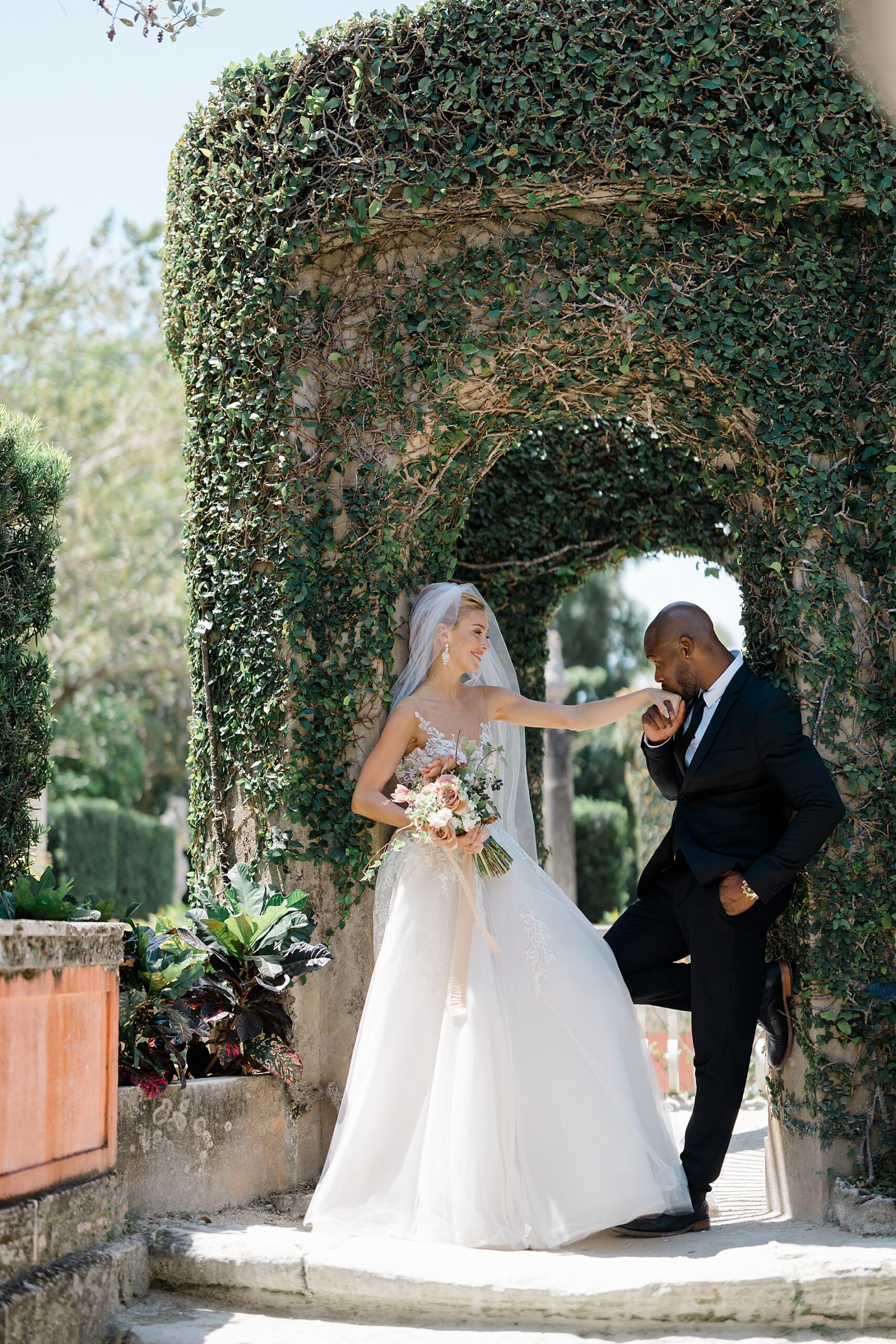 groom kisses bride's hand 