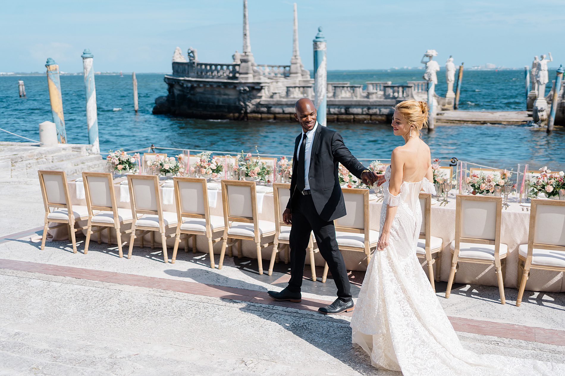 bride and groom photos by the water in Miami FL at Vizcaya Museum and Gardens 