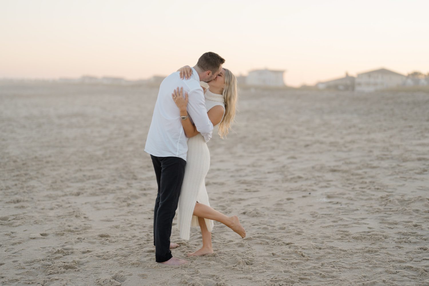 Bride and Groom share a kiss during their engagement session on the beach