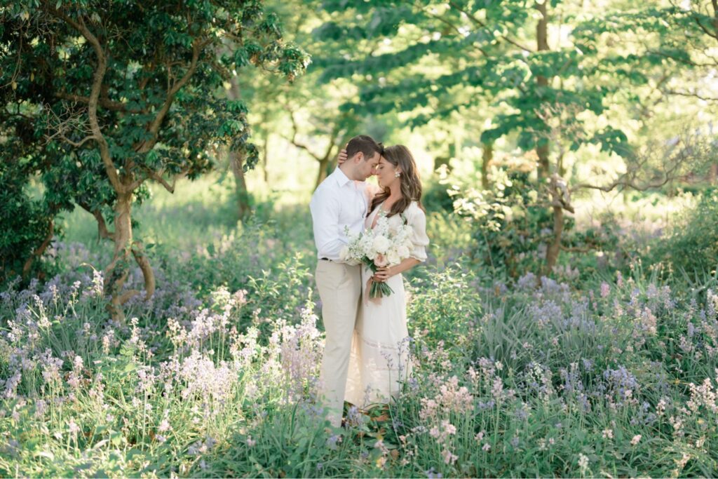 Wide image of couple together in a field of flowers at Glen Foerd