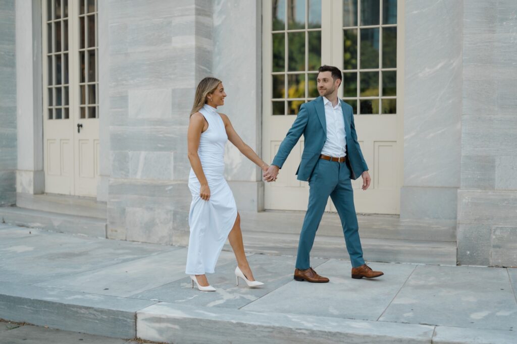 Couple walking together around the Merchants' Exchange in Philadelphia