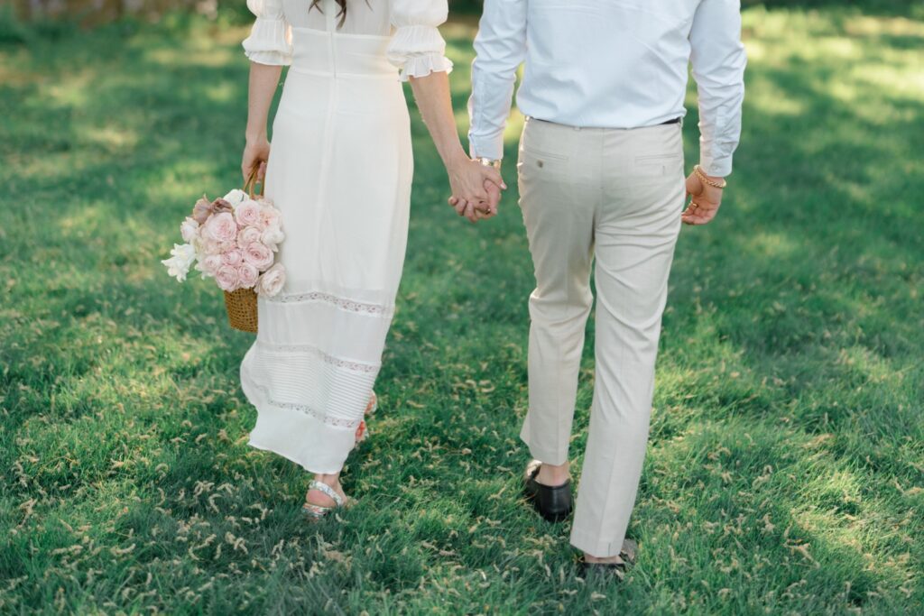 Couple walking hand in hand during engagement session at Glen Foerd