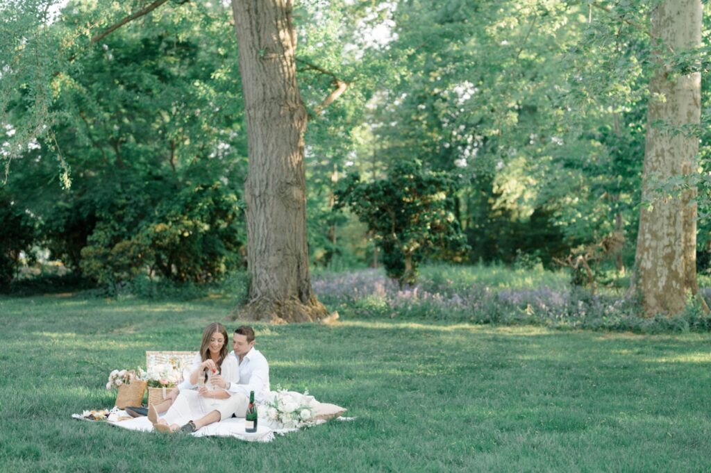 Couple sharing a picnic during engagement session at Glen Foerd