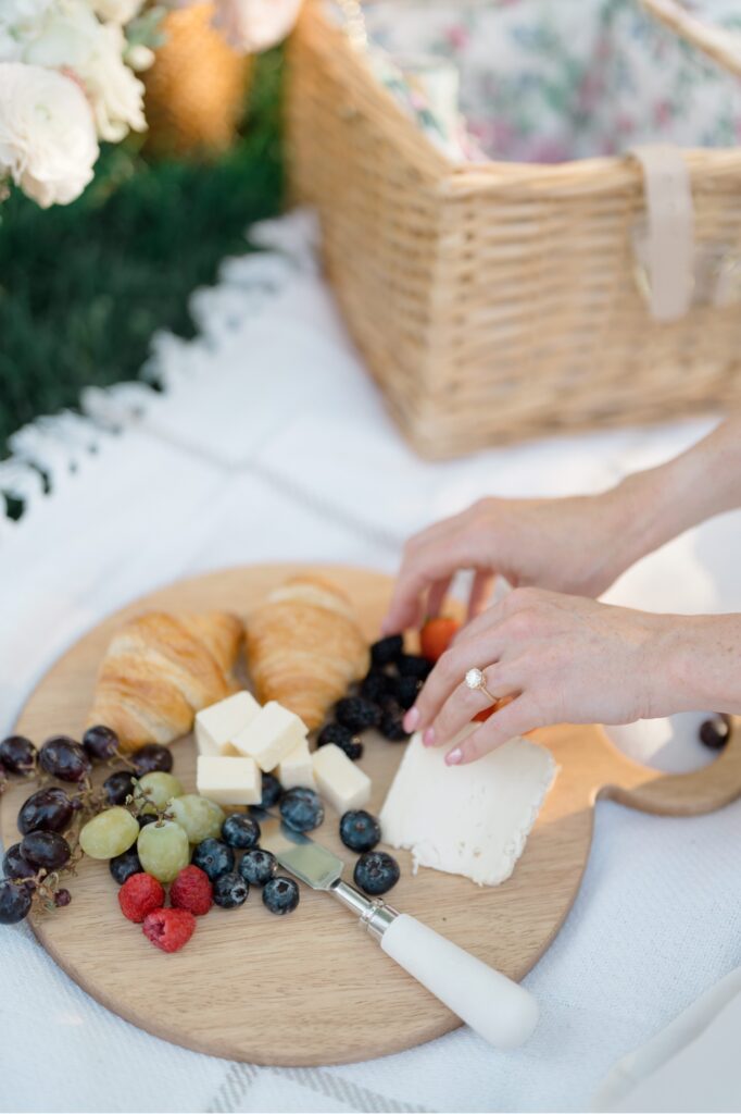 Couple sharing a charcuterie board during engagement session at Glen Foerd