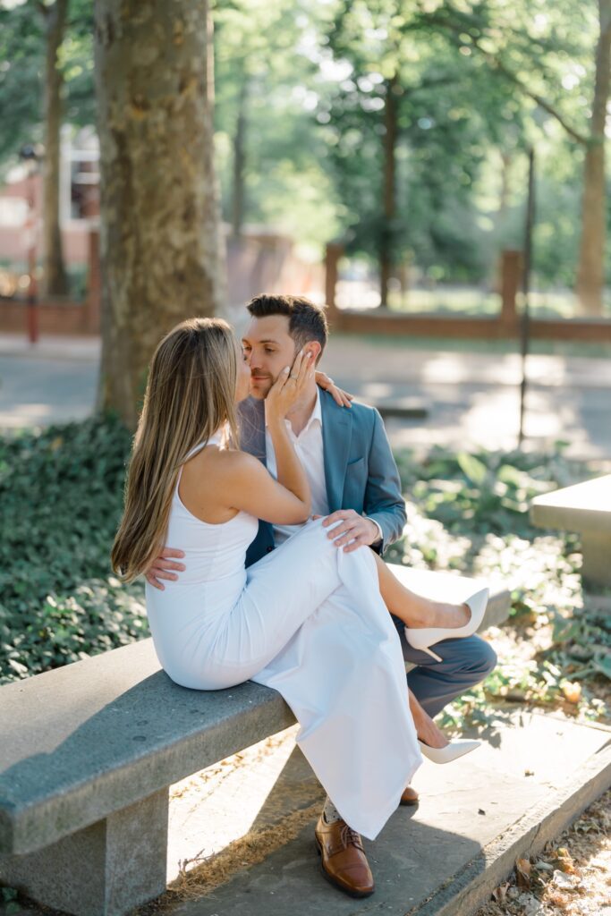 couple sitting together during engagement session at the Merchants' Exchange in Philadelphia