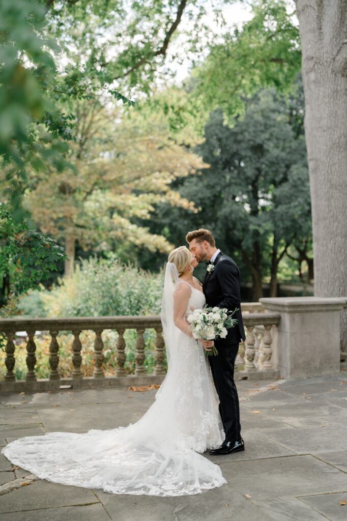 Bride and Groom kiss during first look at Curtis Arboretum wedding