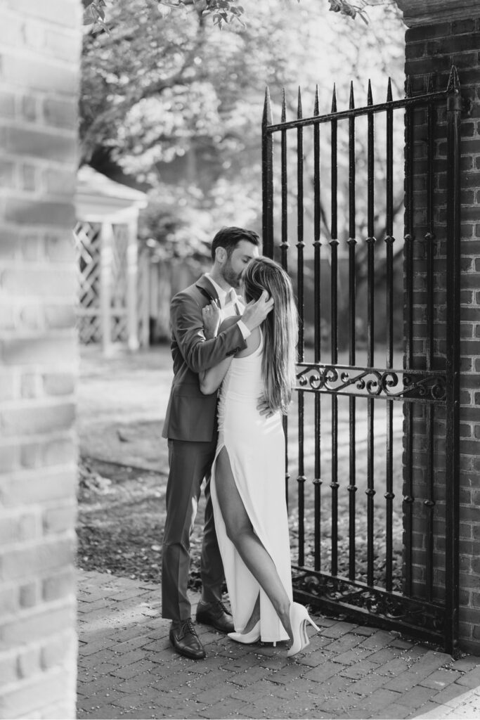 black and white image of Couple sharing a kiss during engagement session at The Merchants' Exchange in Philadelphia
