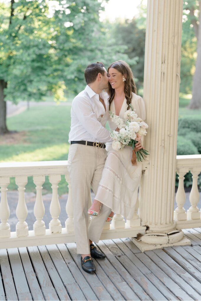 Bride and Groom sit together on the porch of Glen Fored estate