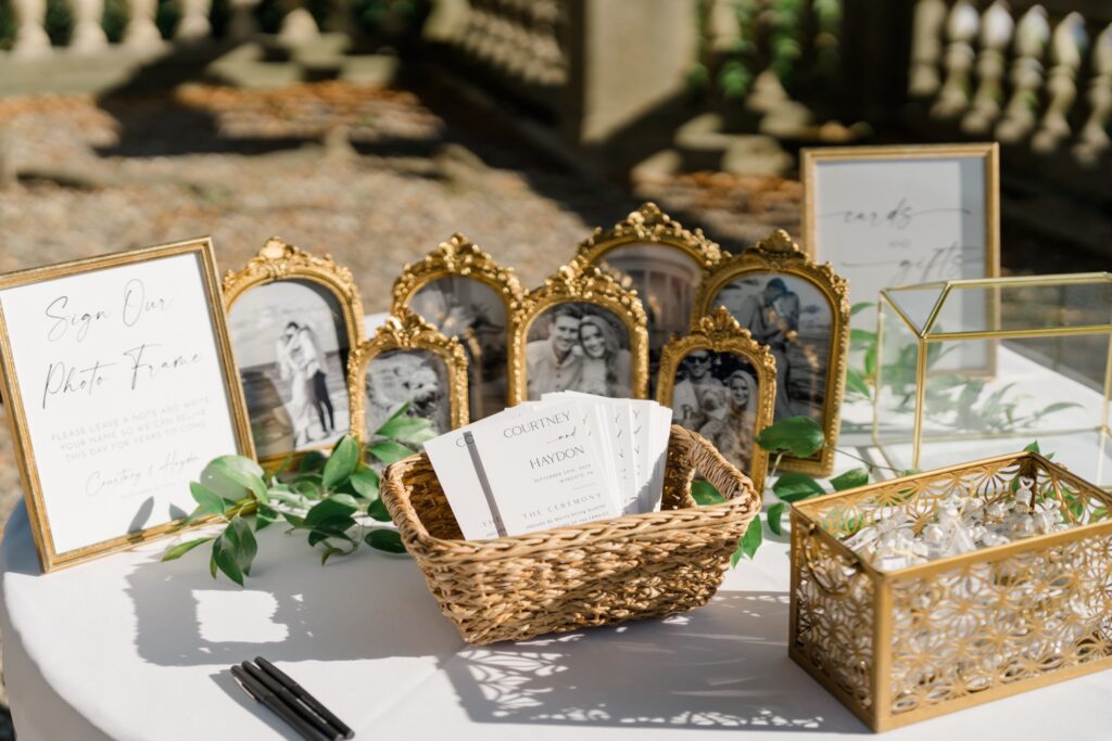 Mirror welcome sign and rose florals at Curtis Arboretum wedding