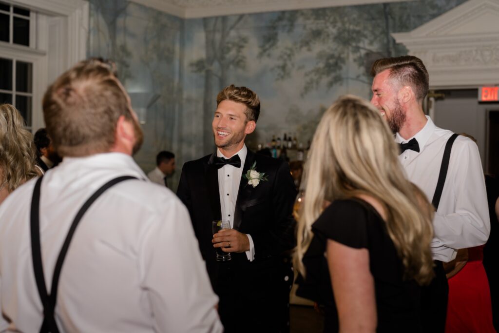 Guests and Groom dancing together during wedding reception at Curtis Arboretum