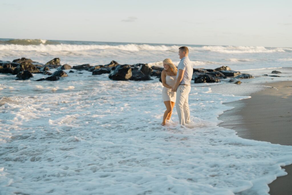 Couple amongst the water during beach engagement session in Sea Girt/Spring Lake