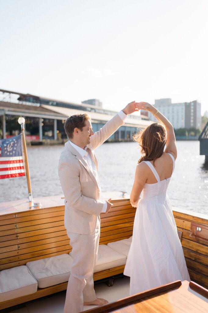 Couple dancing on a boat during engagement session at Sea Philly